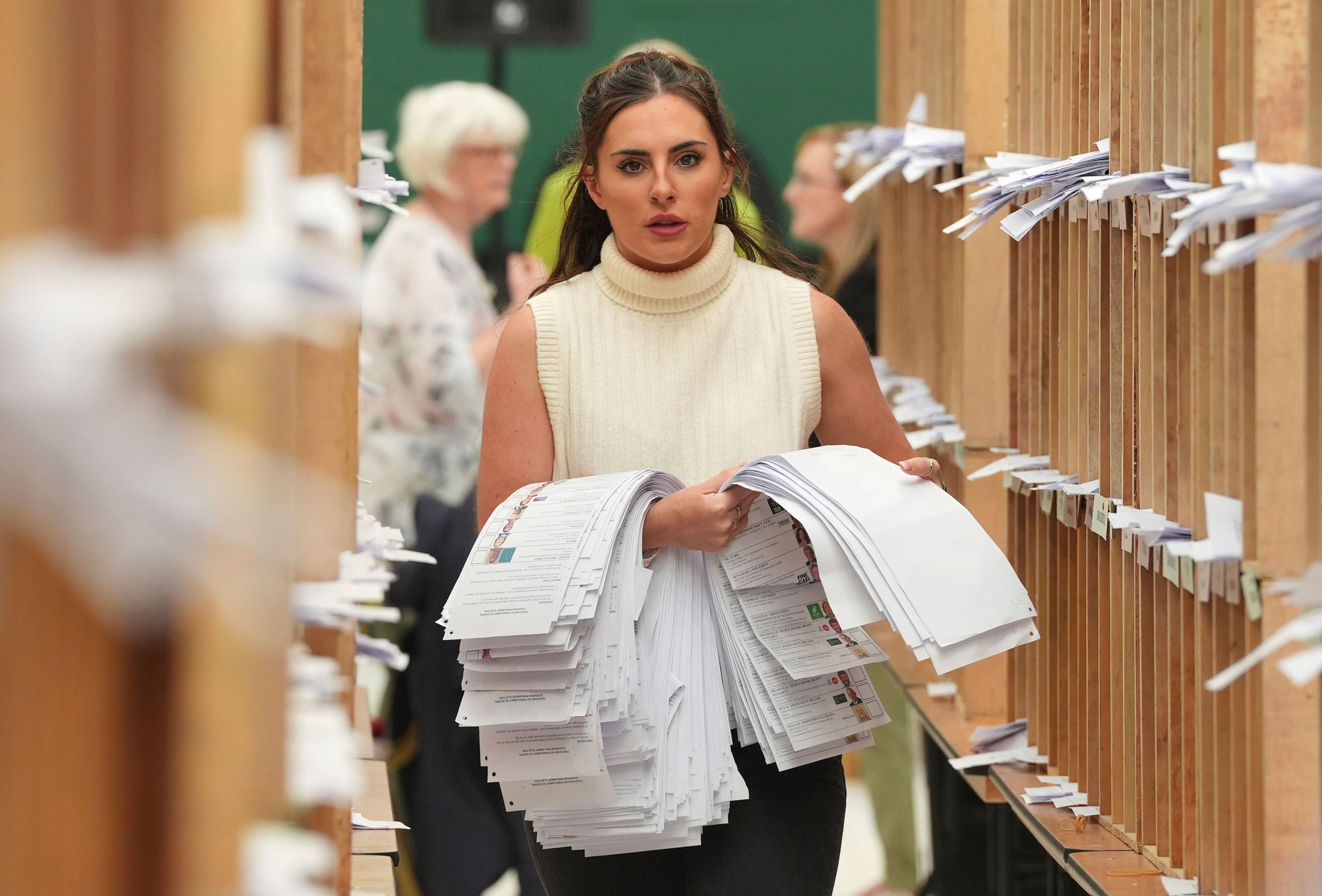 Count staff sort ballots at Nemo Rangers GAA club for the local and European Parliament elections, in Cork, Ireland, Sunday June 9, 2024.