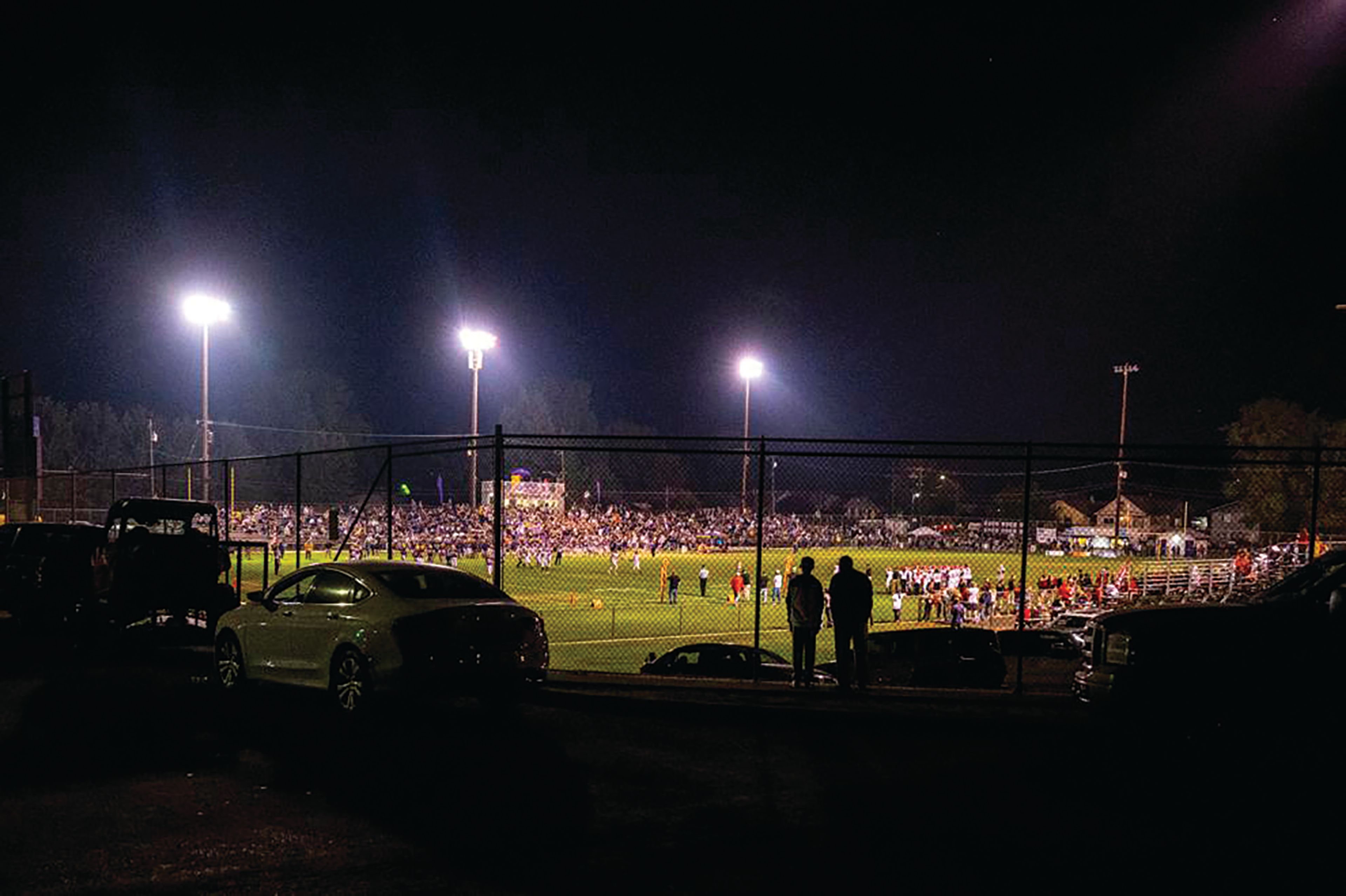 Fans watch outside of Bengal Field during the 2021 Battle of the Bridges football game between Lewiston and Clarkston. For many in the two communities, the game is a time for celebration.