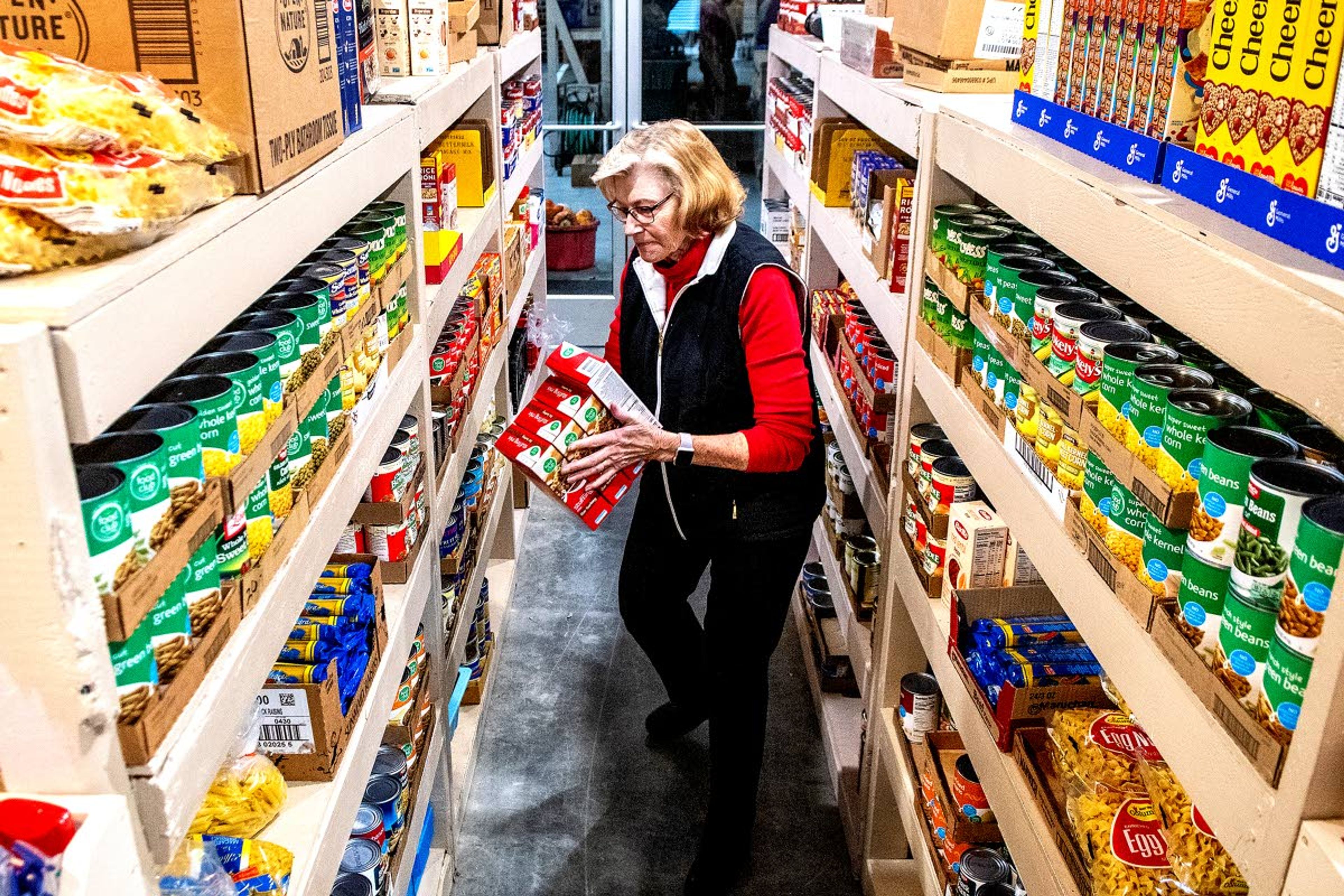 Sue Johnson puts away food in the pantry of the new Camas Prairie Food Bank in Grangeville, after receiving a shipment from Lewiston.