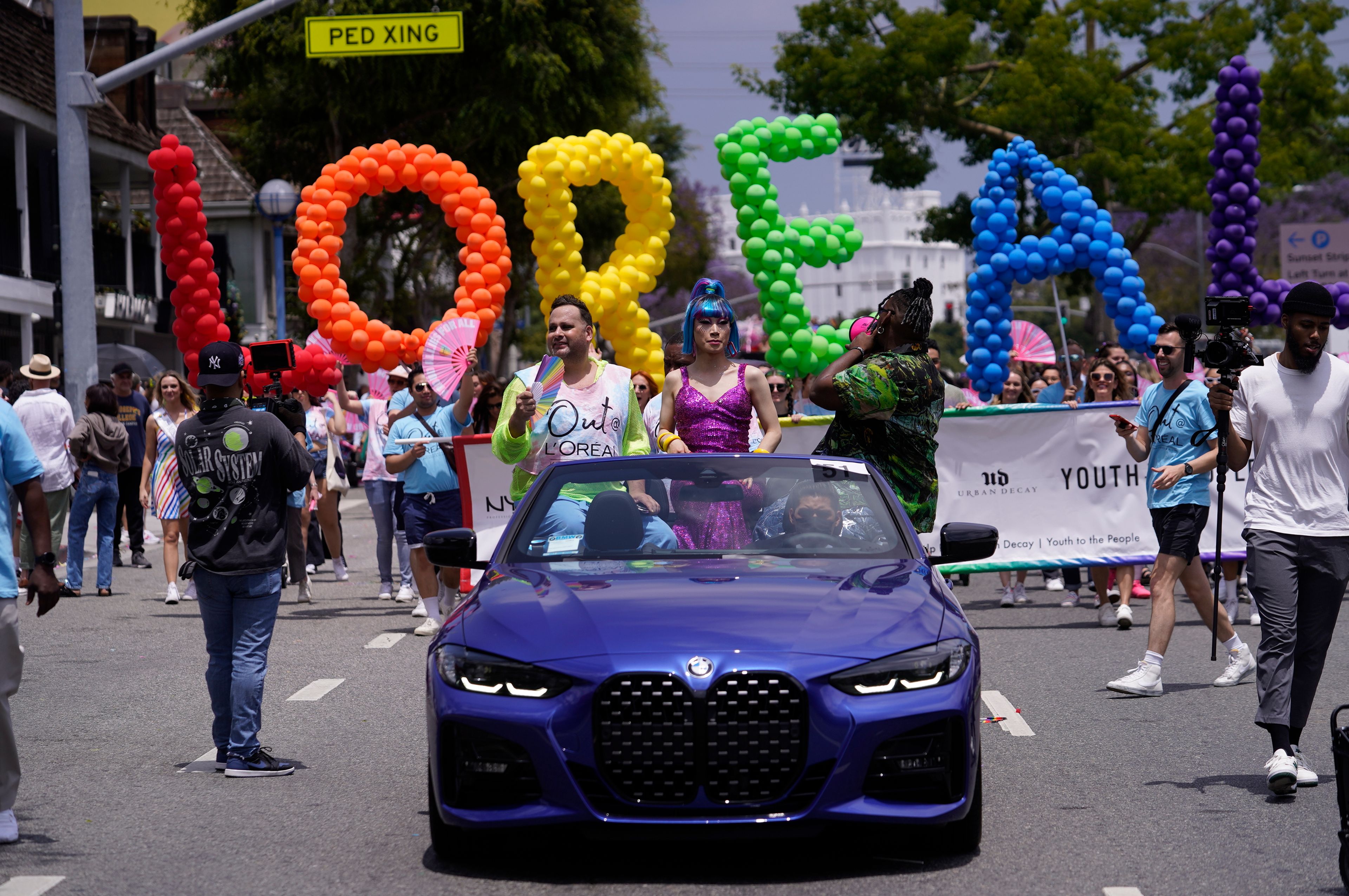 The cosmetics brand L'Oréal is spelled with colorful balloons at the WeHo Pride Parade in West Hollywood, Calif., on Sunday, June 4, 2023. Longtime Pride sponsors have come under attack by conservatives for their LGBTQ-friendly marketing. (AP Photo/Damian Dovarganes)