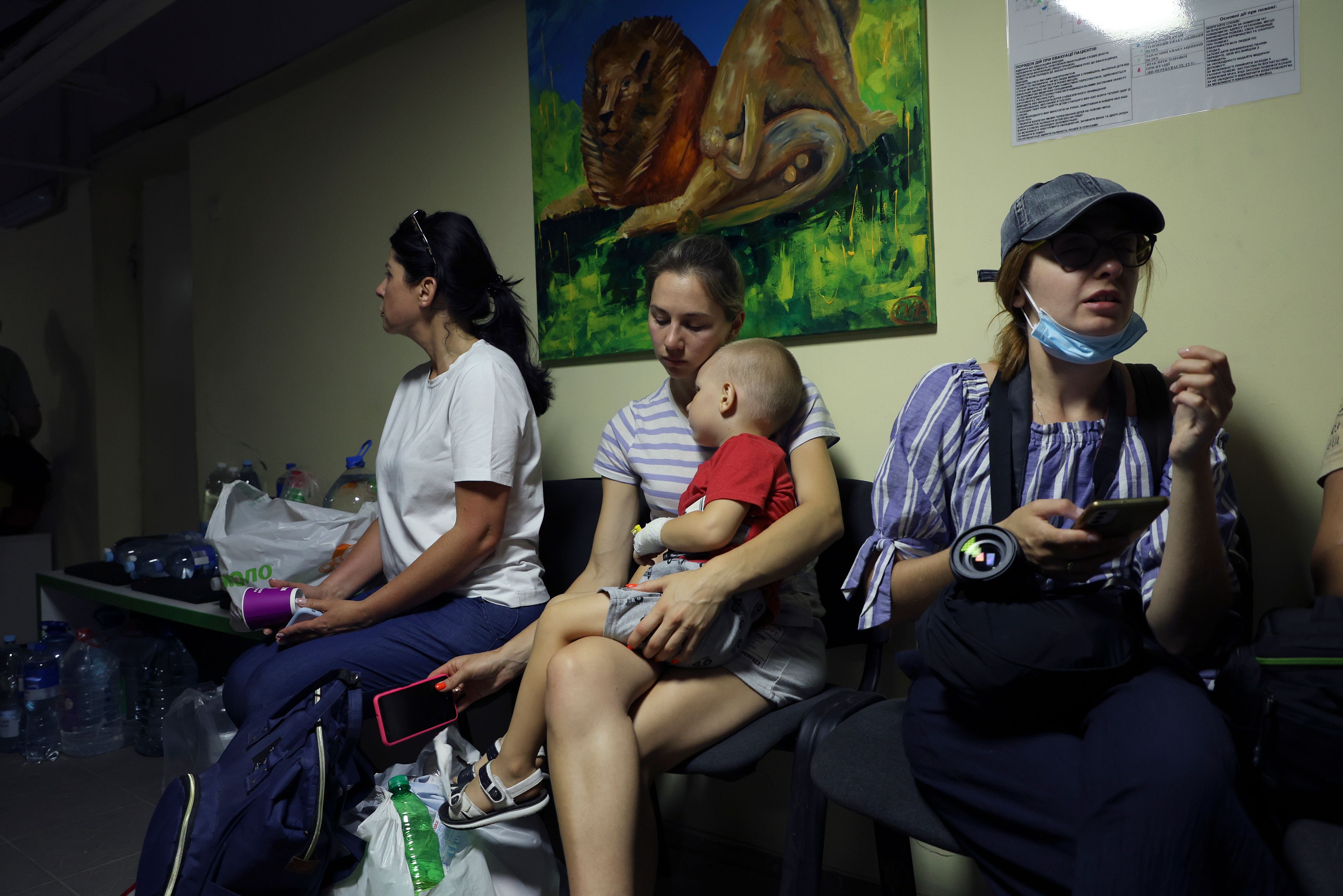 People take shelter in a basement after a Russian missile hit the country's main children's hospital Okhmadit in Kyiv, Ukraine, Monday, July 8, 2024. The daytime barrage targeted five Ukrainian cities with more than 40 missiles of different types hitting apartment buildings and public infrastructure, President Volodymyr Zelenskyy said on social media. (AP Photo/Anton Shtuka)