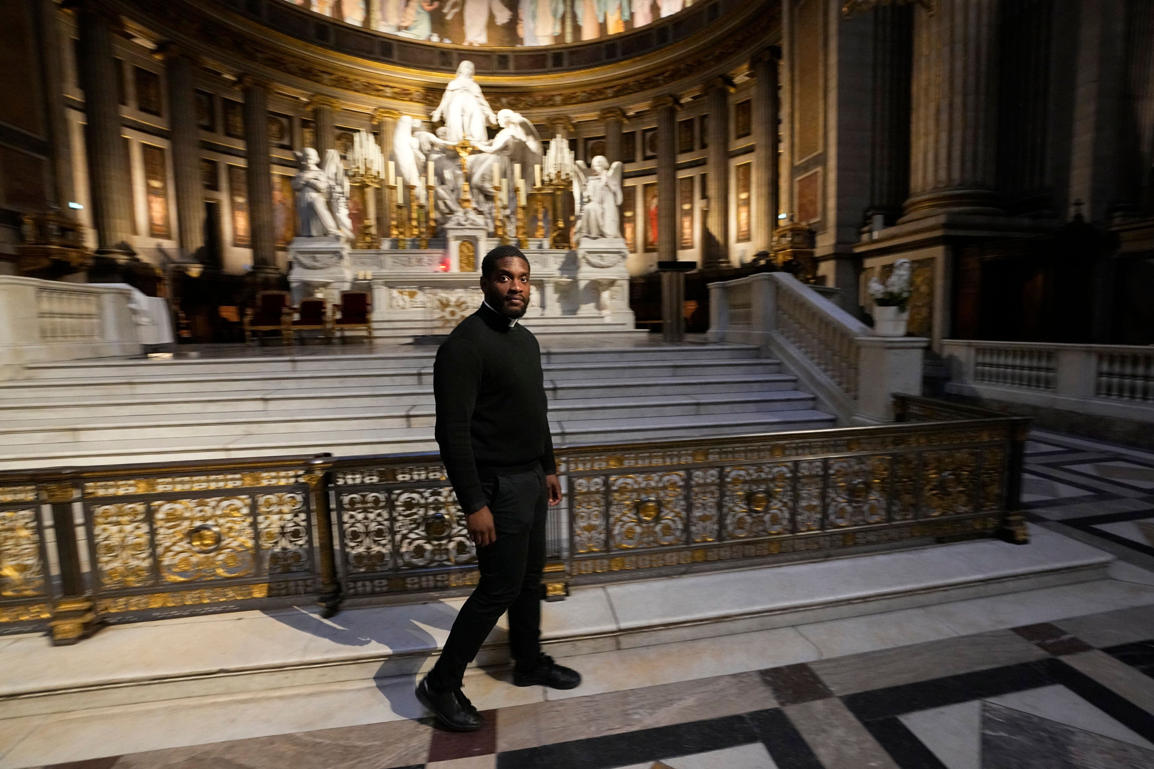 Jason Nioka, a former judo champion and deacon who's in charge of the largest contingent of Olympic chaplains, about 40 priests, nuns and lay Catholics, walks inside the Madeleine church, Thursday, May 30, 2024 in Paris. As athletes rev up their training and organizers finalize everything from ceremonies to podiums before the Paris Olympics, more than 120 faith leaders are preparing for a different challenge – spiritually supporting some 14,000 participants from around the world, especially those whose medal dreams will inevitably get crushed.