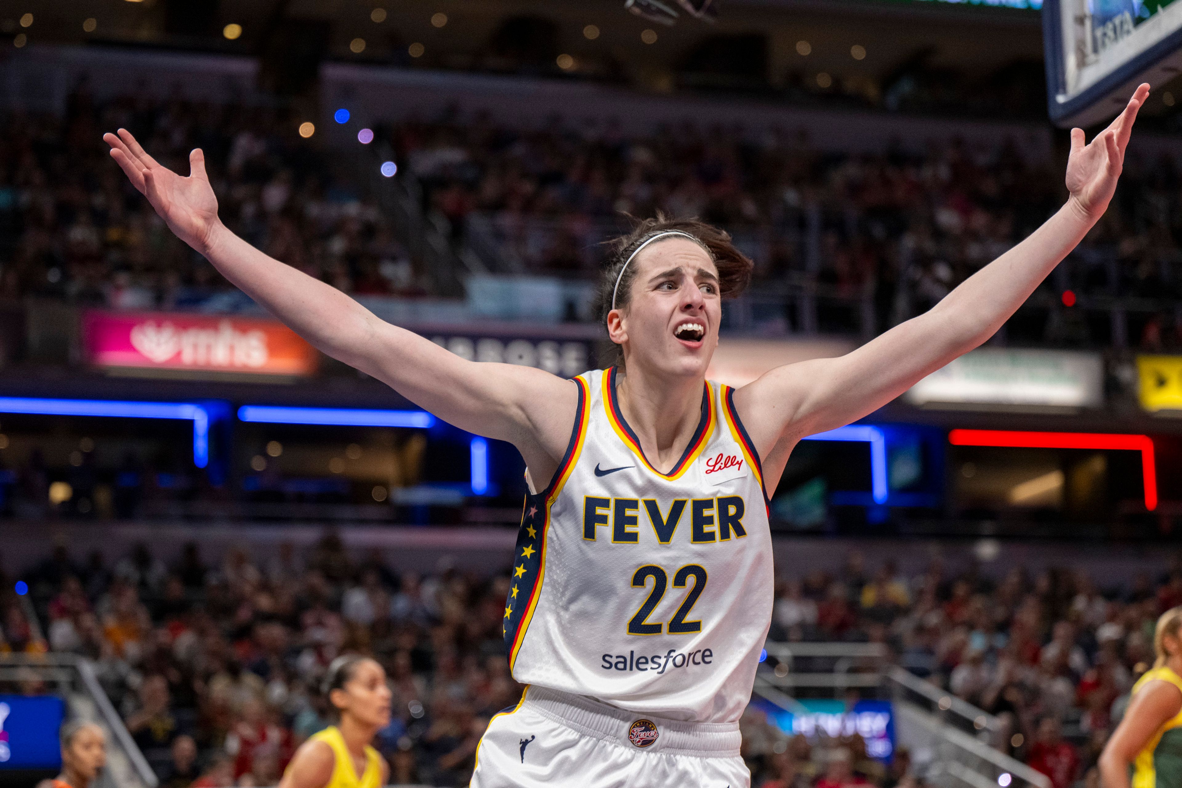 FILE - Indiana Fever guard Caitlin Clark reacts after scoring against the Seattle Storm during the first half of a WNBA basketball game Thursday, May 30, 2024, in Indianapolis.