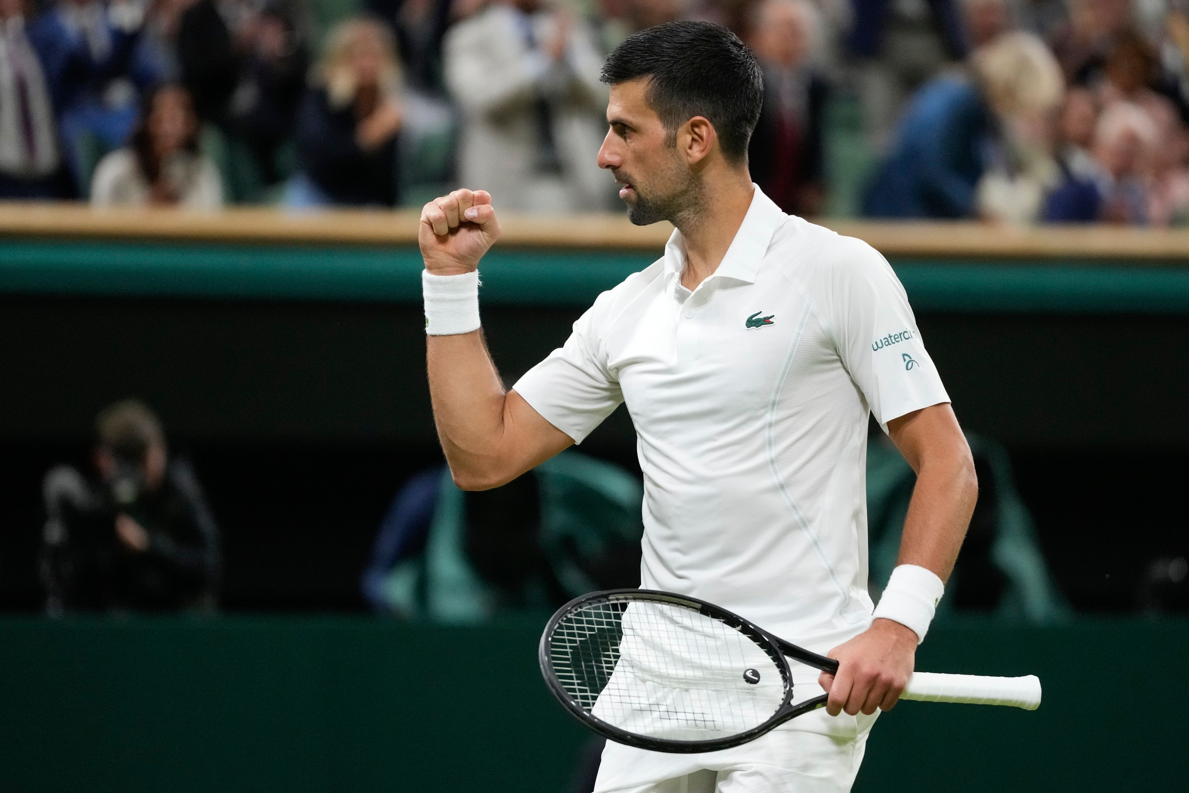 Novak Djokovic of Serbia celebrates after defeating Holger Rune of Denmark in their fourth round match at the Wimbledon tennis championships in London, Monday, July 8, 2024. (AP Photo/Kirsty Wigglesworth)