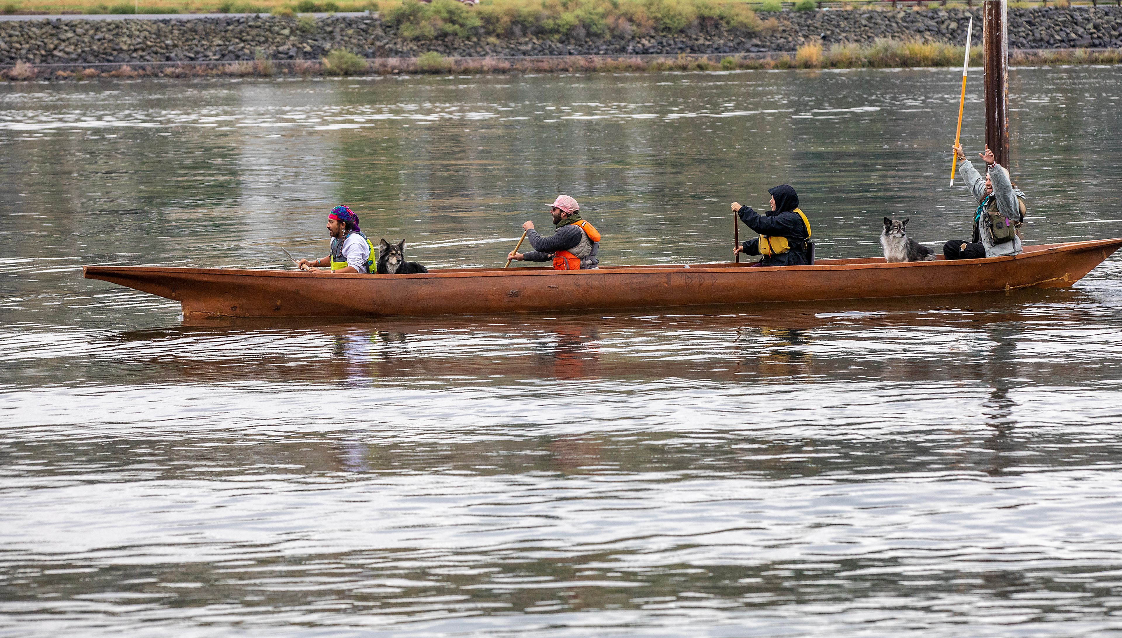 People paddle along the shoreline in the Snake River during a demonstration calling for breaching the dams Saturday at Hells Gate State Park in Lewiston.