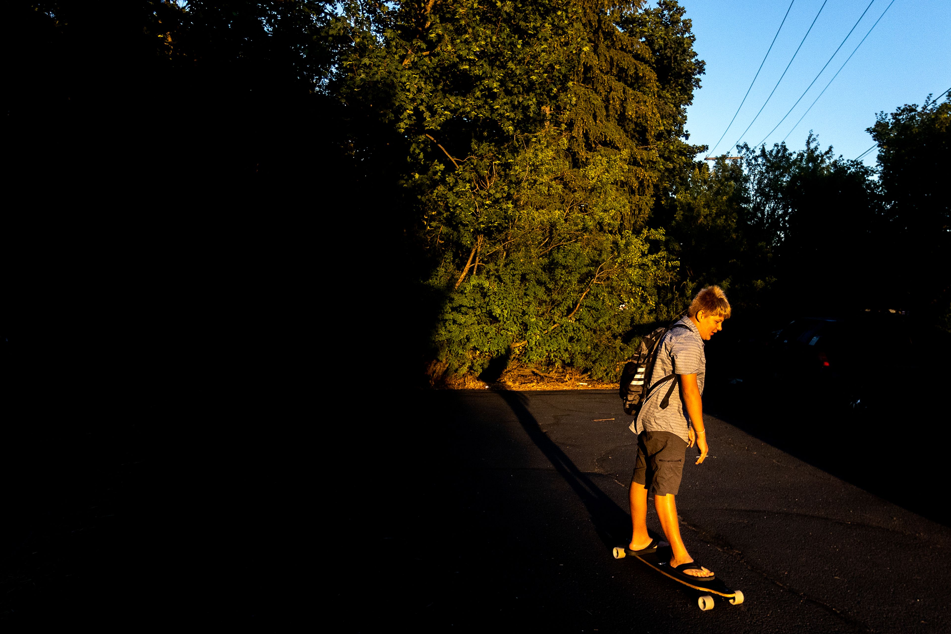 Tony Poulsen rides the longboard he purchased with birthday money around the front drive of their home on Friday.