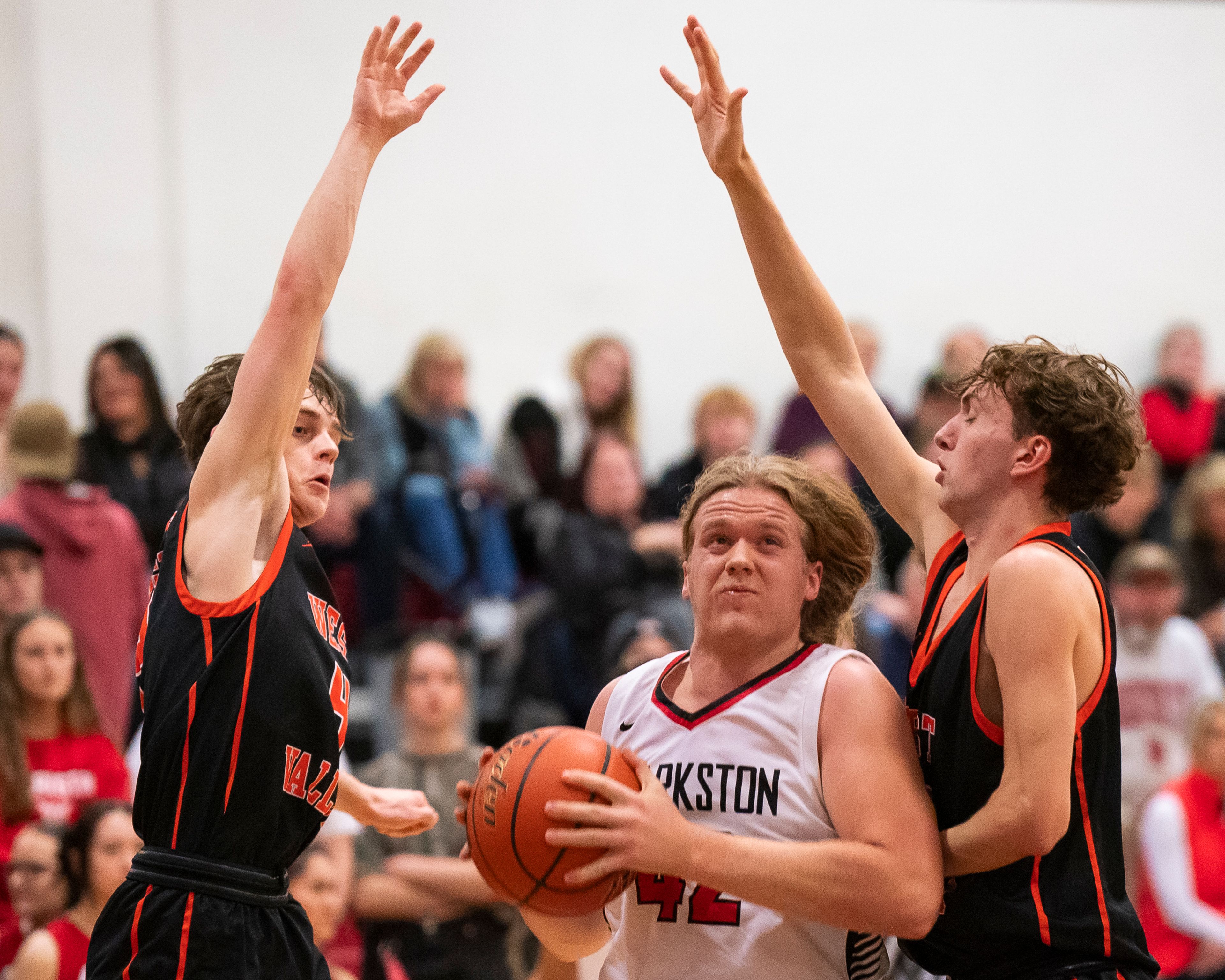 Clarkston’s Ian Moore (42) drives to the basket during their game against West Valley on Tuesday at Clarkston High School.