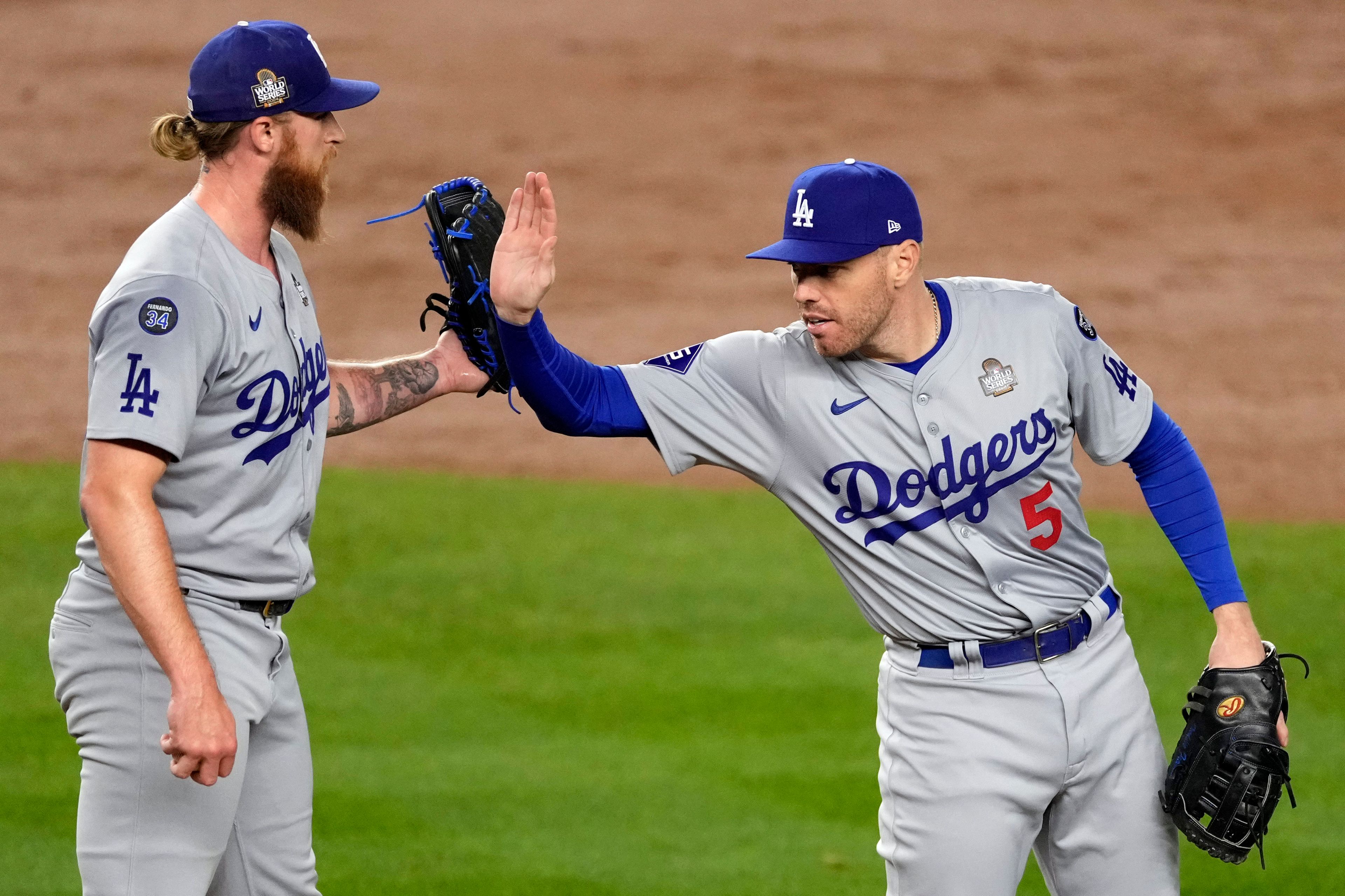 Los Angeles Dodgers' Freddie Freeman (5) and Michael Kopech celebrate after Game 3 of the baseball World Series against the New York Yankees, Monday, Oct. 28, 2024, in New York. The Dodgers won 4-2. (AP Photo/Seth Wenig)