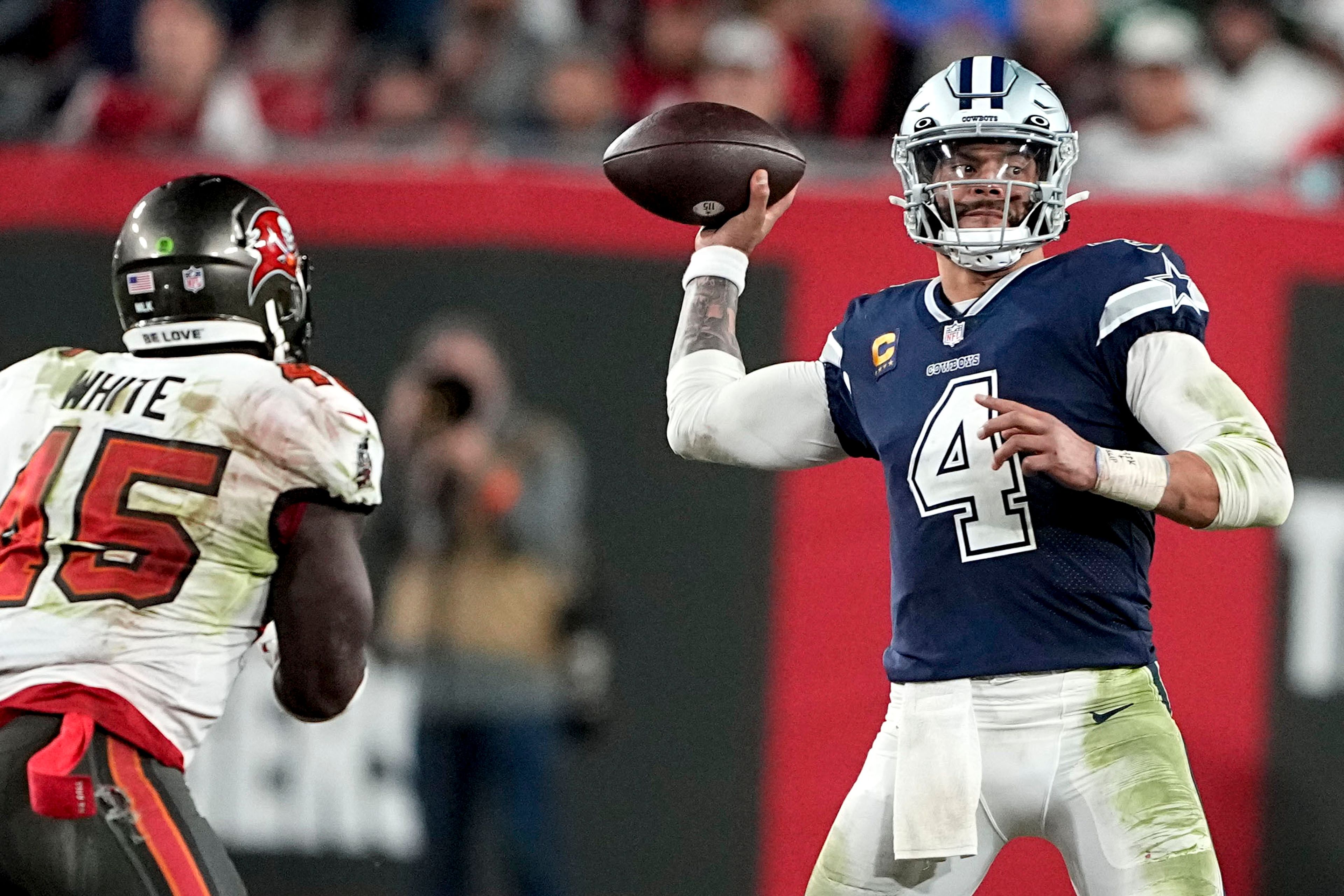 Dallas Cowboys quarterback Dak Prescott (4) passes in the pocket as Tampa Bay Buccaneers linebacker Devin White (45) drives in during the second half of an NFL wild-card football game, Monday, Jan. 16, 2023, in Tampa, Fla. (AP Photo/Chris Carlson)