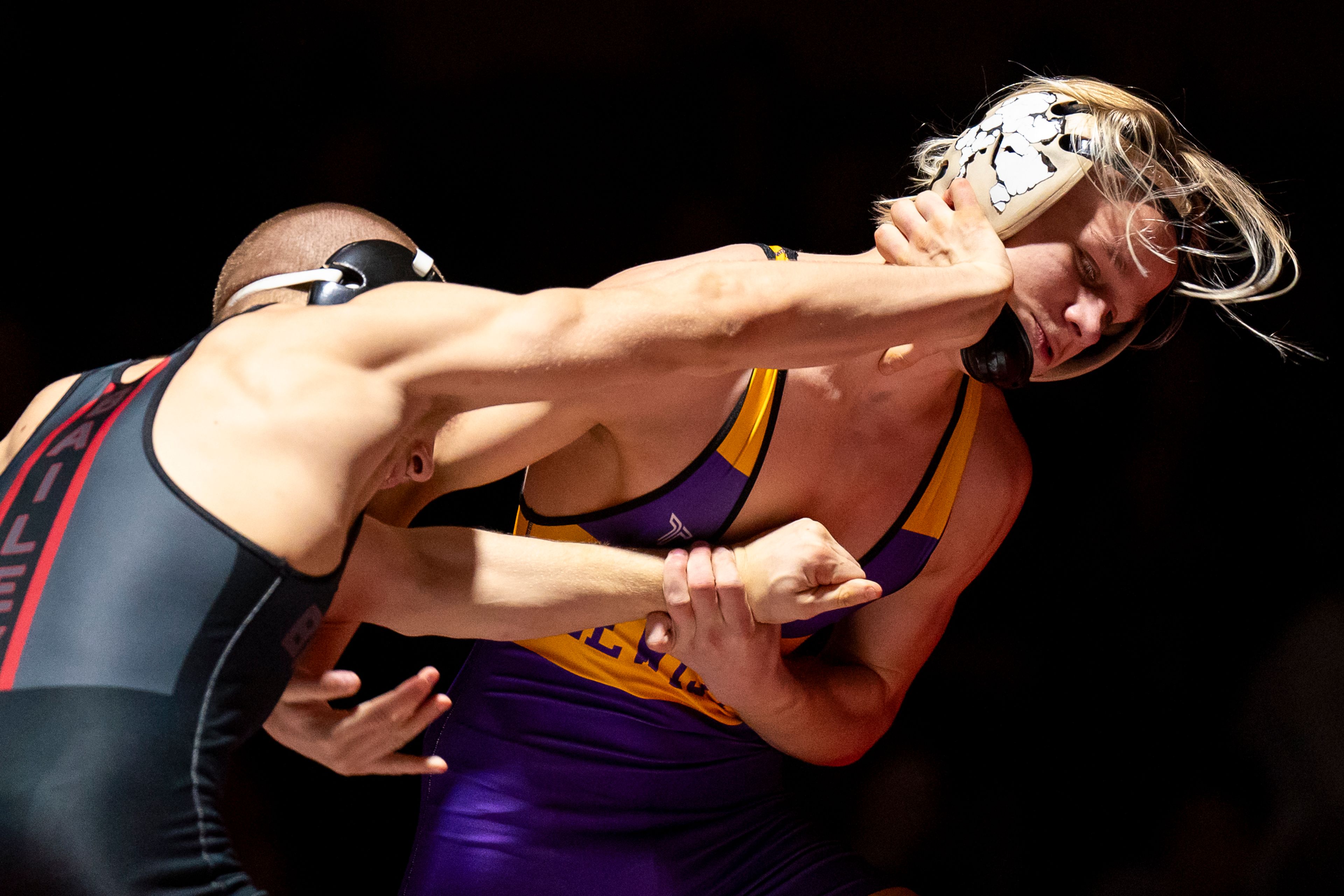 Clarkston’s Dawson Bailey, left, uses his hand to push Lewiston’s Hoyt Hvass during a 132-pound match Jan. 24 at Kramer Gym in Clarkston.