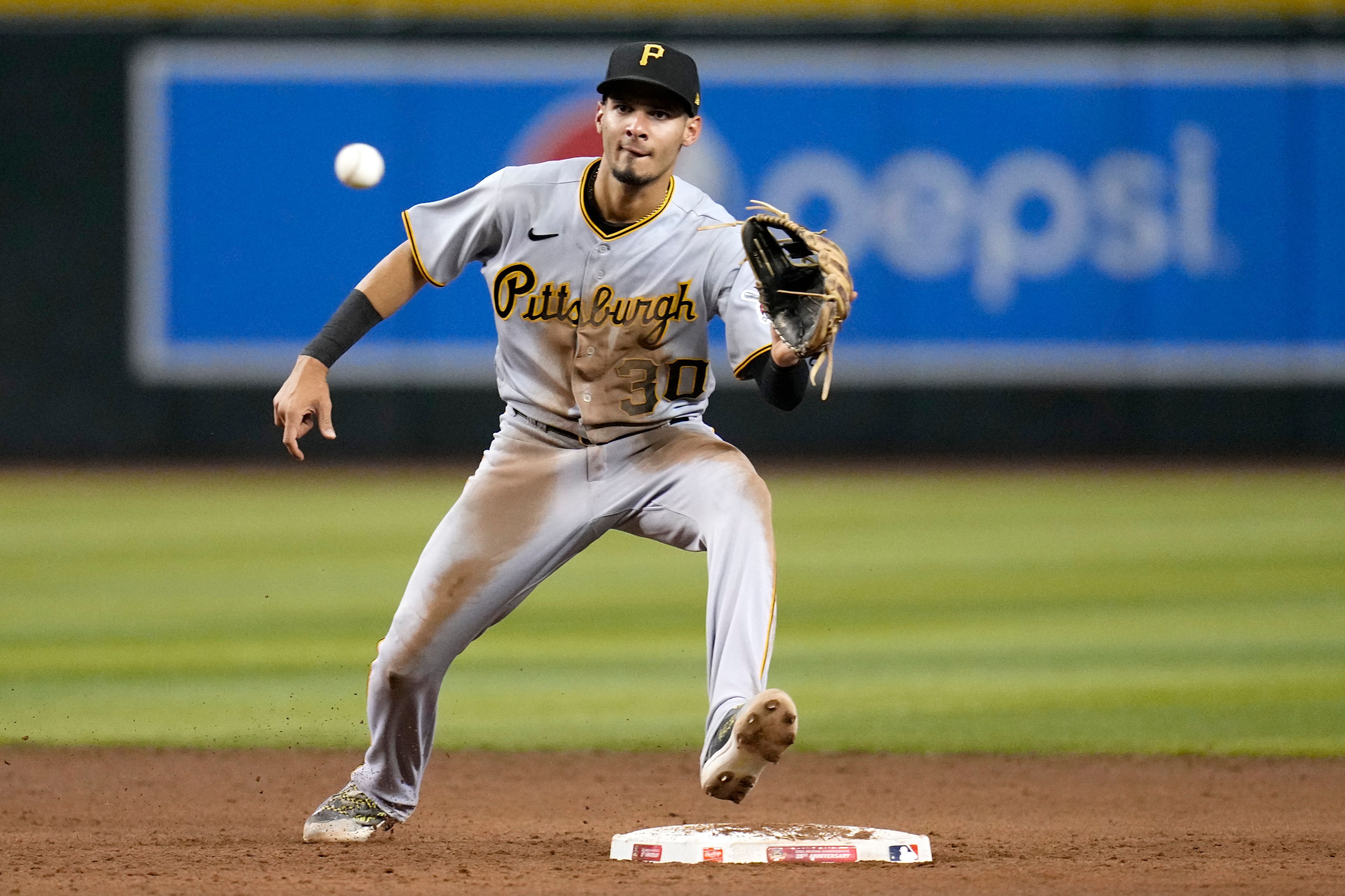 FILE - Pittsburgh Pirates shortstop Tucupita Marcano takes a throw down to second base during the fifth inning of a baseball game against the Arizona Diamondbacks, July 7, 2023, in Phoenix. Major League Baseball has permanently banned Marcano, Tuesday, June 4, 2024, for betting on baseball and suspended the four other players for one year after finding the players placed unrelated bets with a legal sportsbook.