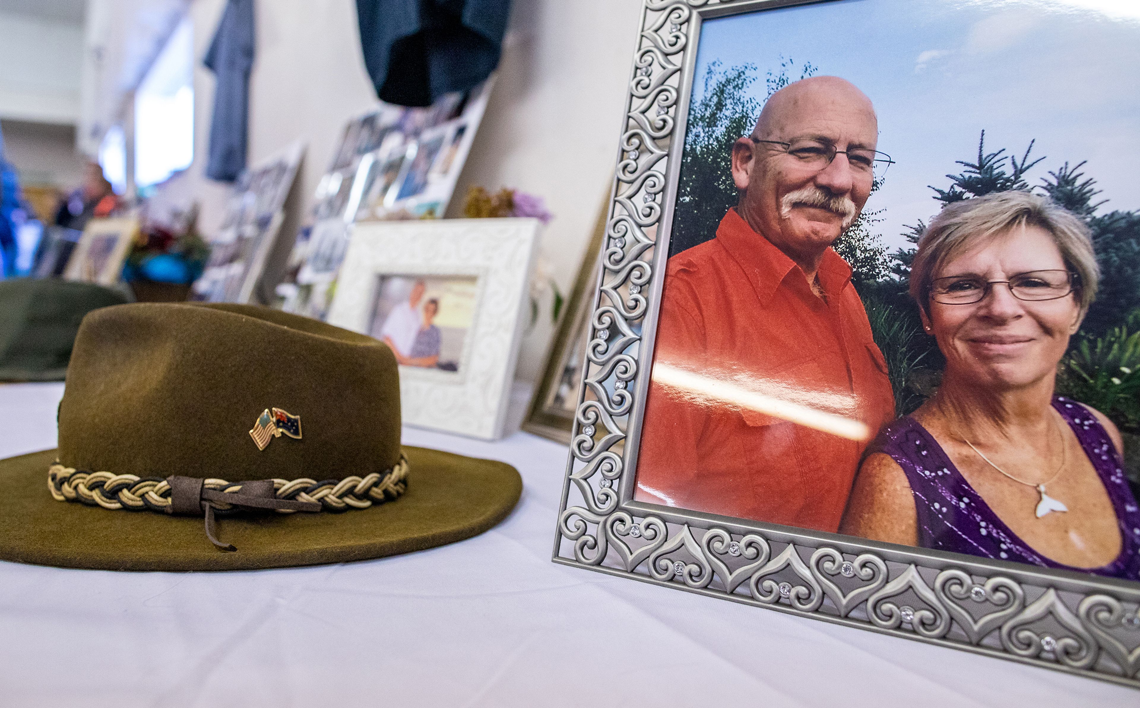 A photo of Wayne Hirschel with his wife of almost 30 years, Lona, sits on a table covered with photos and memorabilia honoring Hirschel’s life Nov. 19 during his memorial in the Bennett Building of the Asotin County Fairgrounds in Asotin.