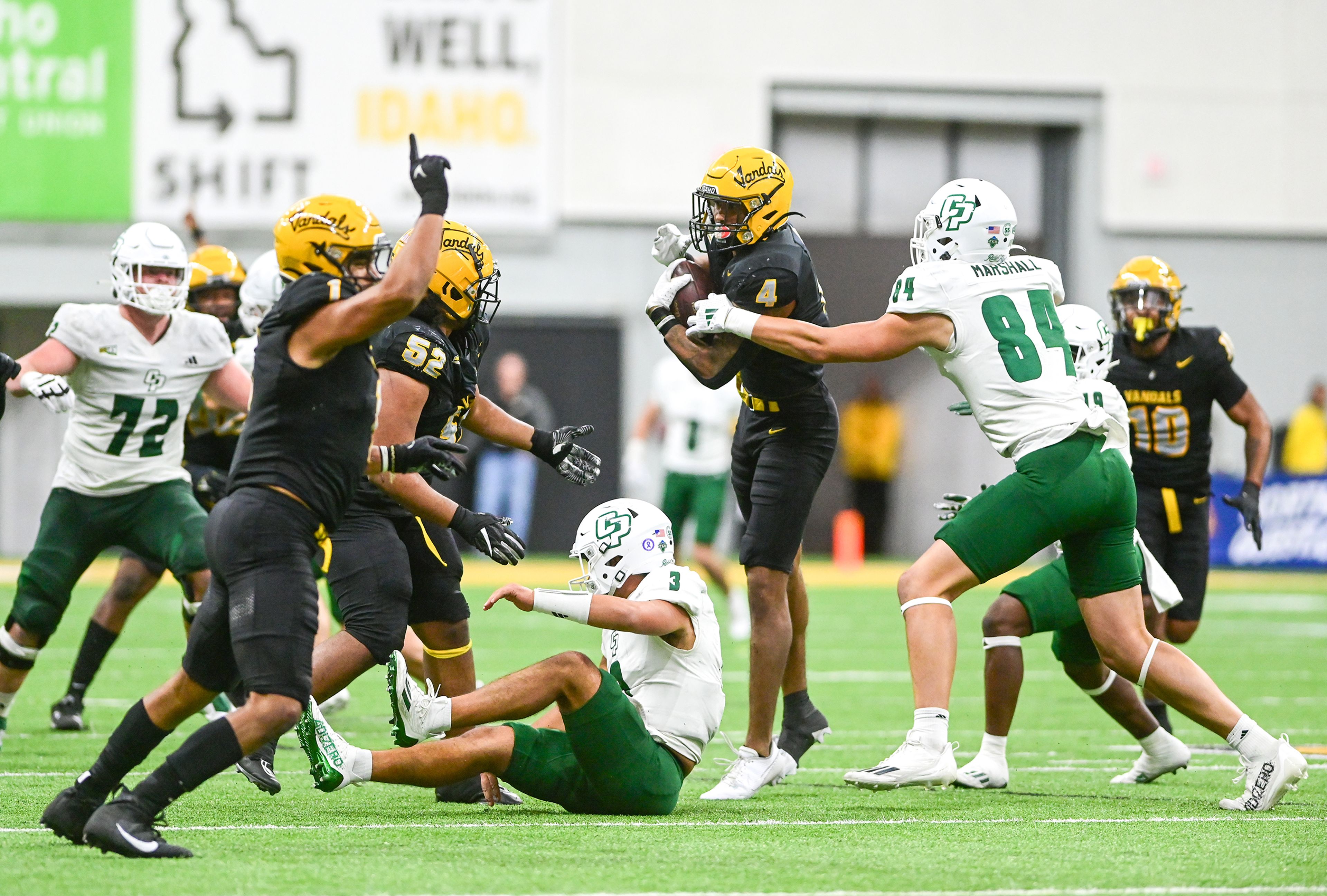 Idaho linebacker Isiah King, center, recovers a Cal Poly fumble Saturday at the P1FCU Kibbie Dome in Moscow.,