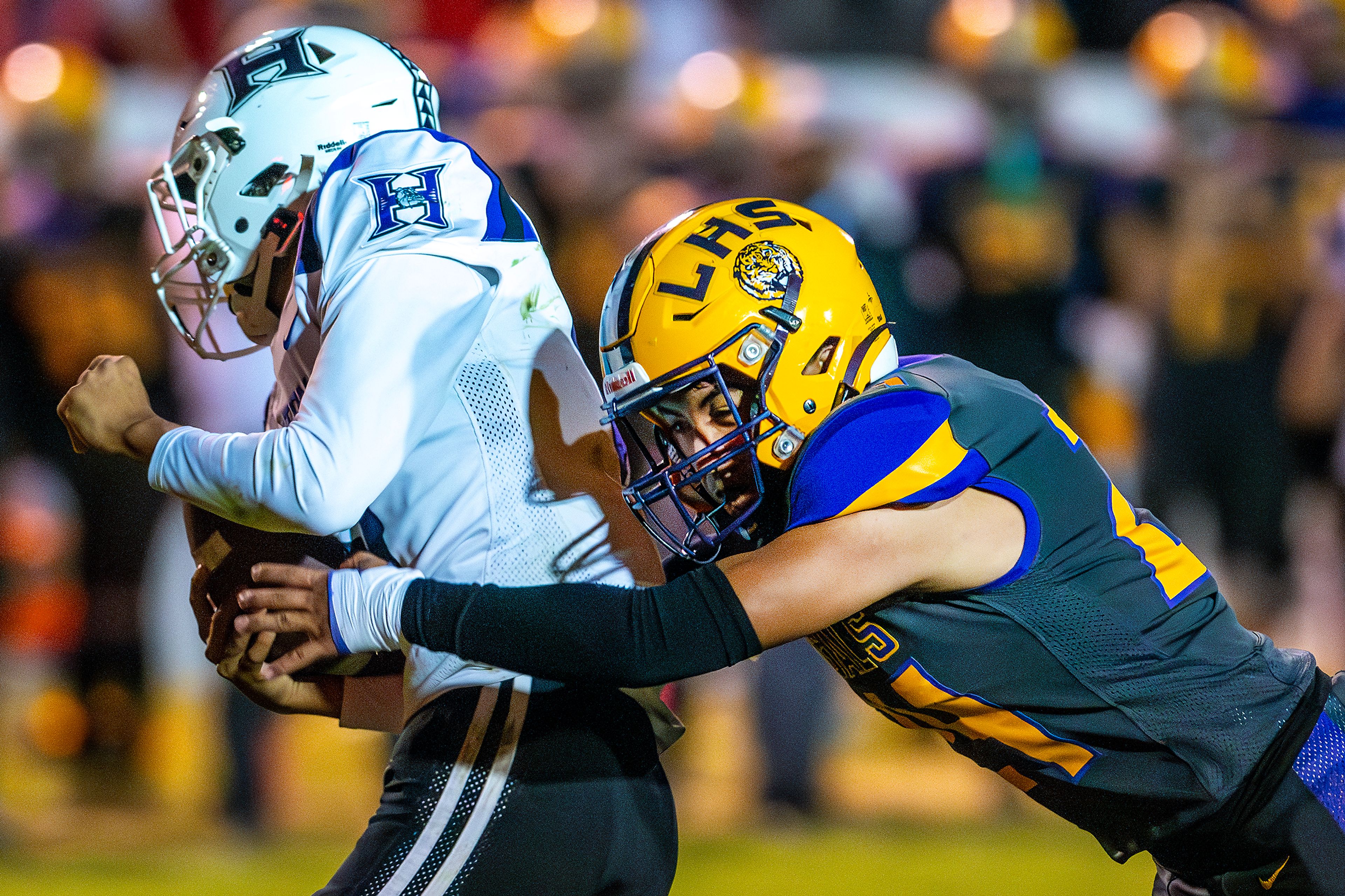 Lewiston linebacker Isaiah Rinehart looks to stop a run by Hermiston wide receiver Dale Krebs during a nonconference game at Bengal Field Friday in Lewiston.,