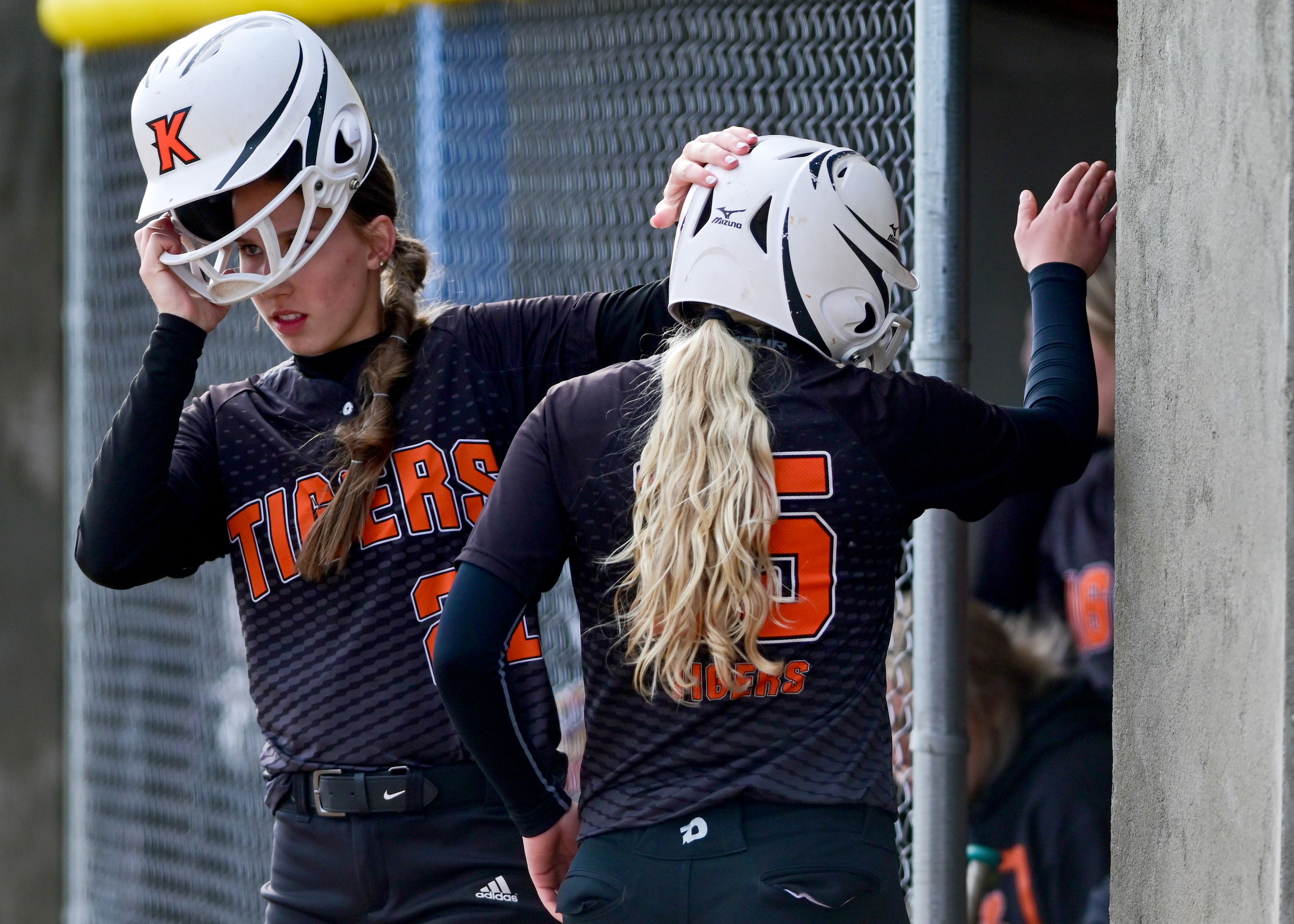 Kendrick’s Hali Anderson, left, pats Lily Hanson’s helmet in celebration of Hanson scoring a run during an Idaho 2A district tournament championship game Wednesday in Genesee.