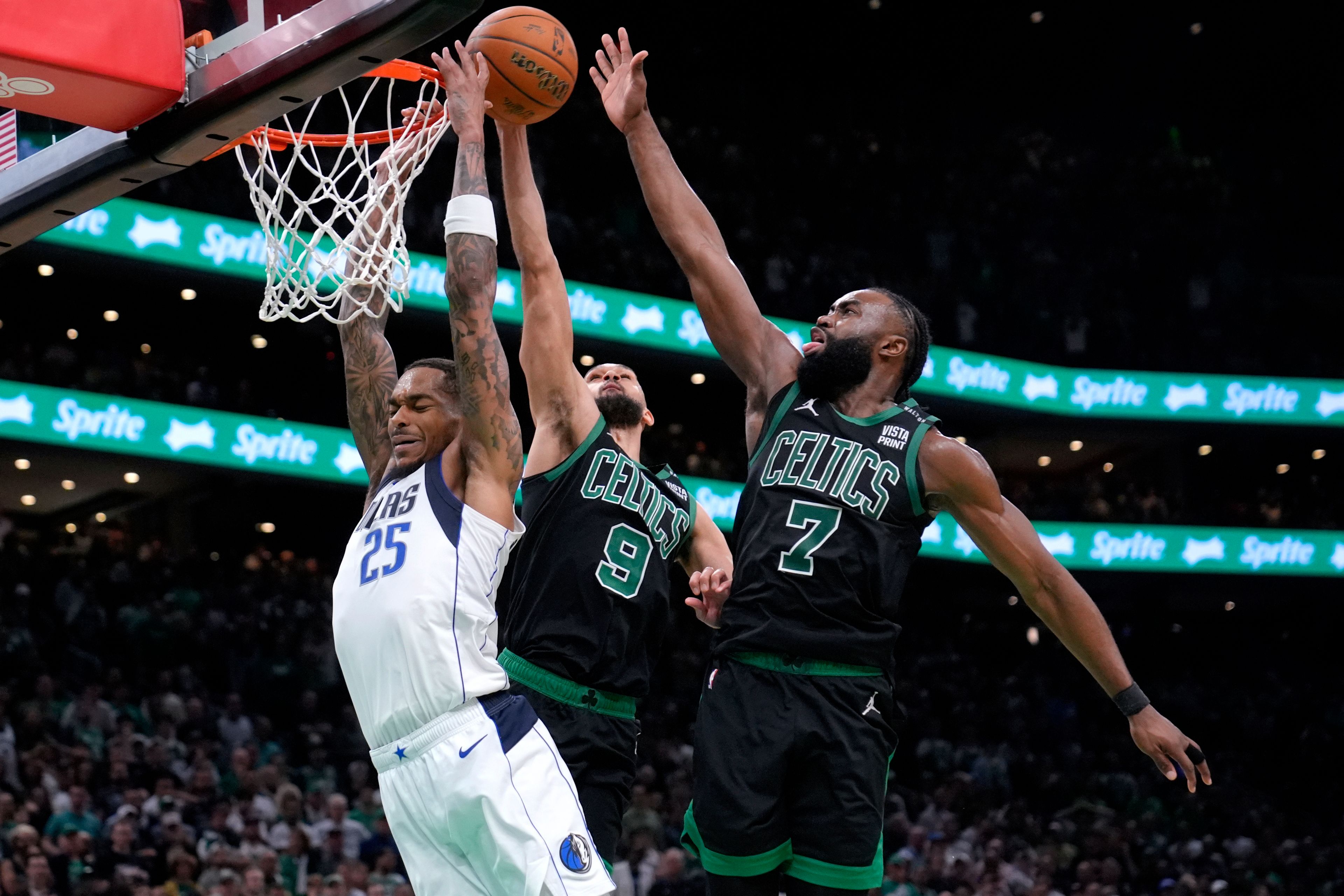 Dallas Mavericks forward P.J. Washington (25) is blocked by Boston Celtics' Derrick White (9) and Jaylen Brown (7) during the second half of Game 2 of the NBA Finals basketball series, Sunday, June 9, 2024, in Boston.