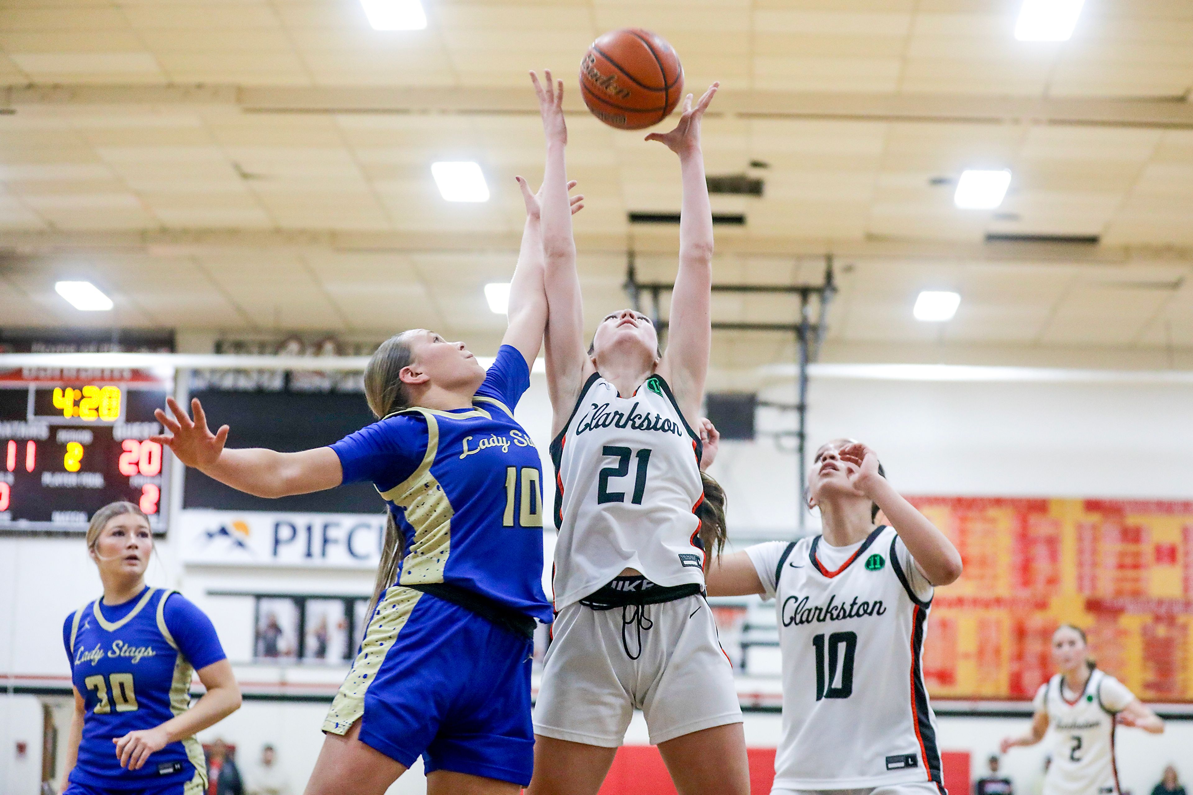 Clarkston post Laney Augir grabs a rebound over Deer Park guard Jacey Boesel Saturday during the 2A Greater Spokane League district tournament championship game in Clarkston.