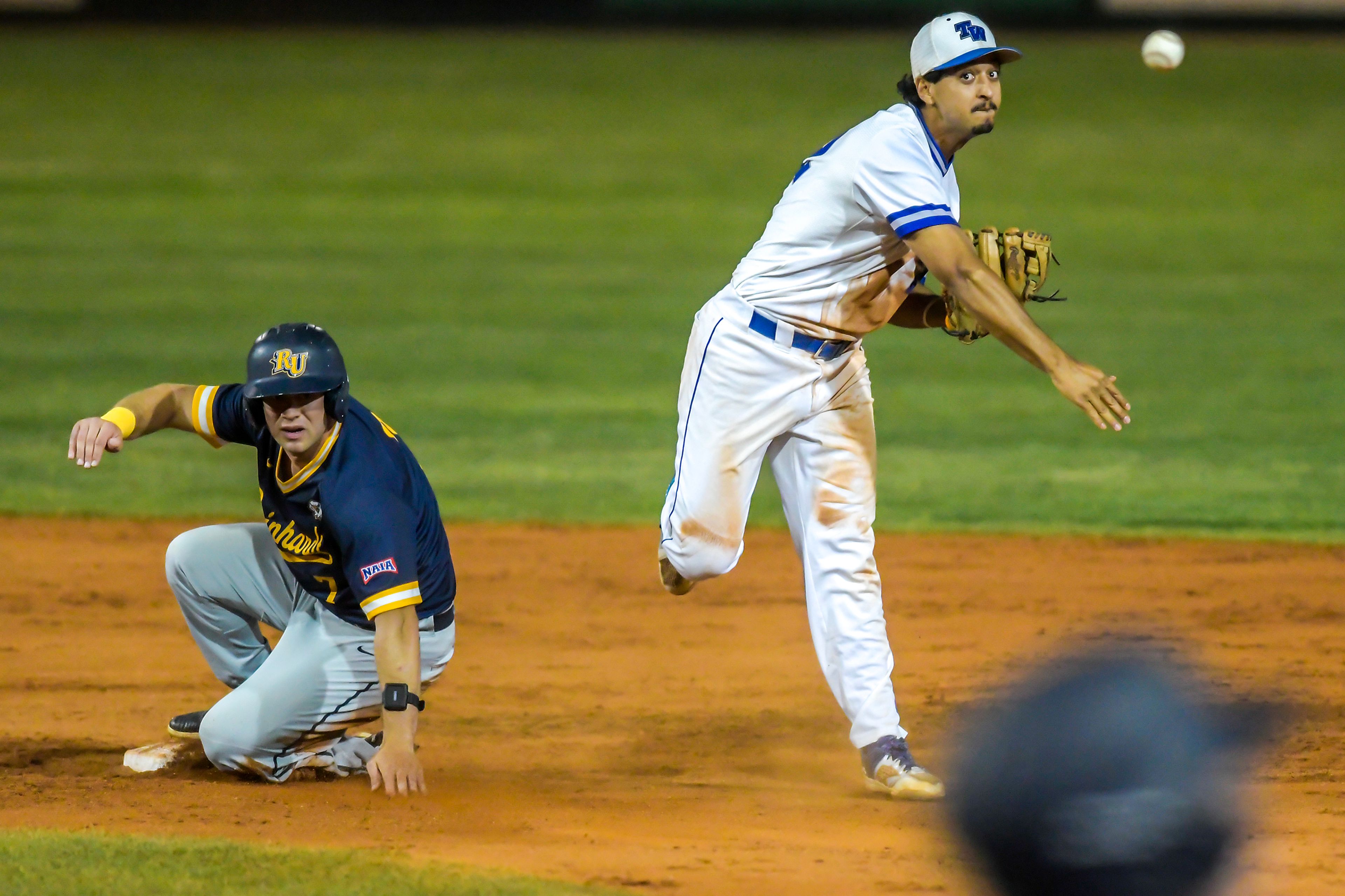 Tennessee Wesleyan shortstop Marco Martinez throws to first after tagging out Tucker Zdunich to end an extra inning in Game 18 of the NAIA World Series at Harris Field Thursday in Lewiston.