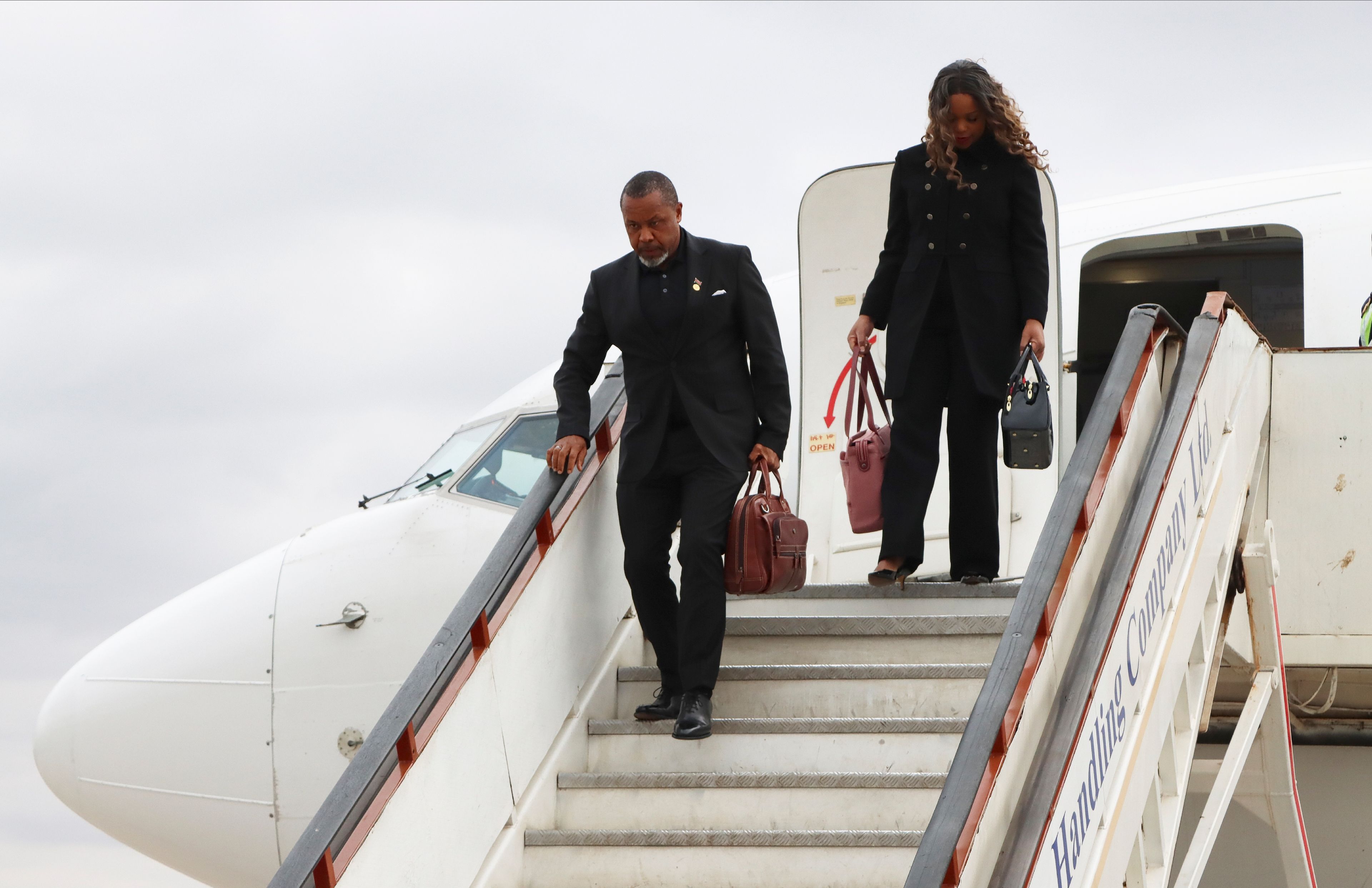 Malawi Vice President Saulos Chilima,left, and his wife Mary disembark from a plane upon his return from South Korea in Lillongwe, Sunday, June 9, 2024. A military plane carrying Malawi's vice president and nine others went missing Monday and a search was underway, the president's office said. The plane carrying 51-year-old Vice President Saulos Chilima left the capital, Lilongwe, but failed to make its scheduled landing at Mzuzu International Airport about 370 kilometers (230 miles) to the north around 45 minutes later.