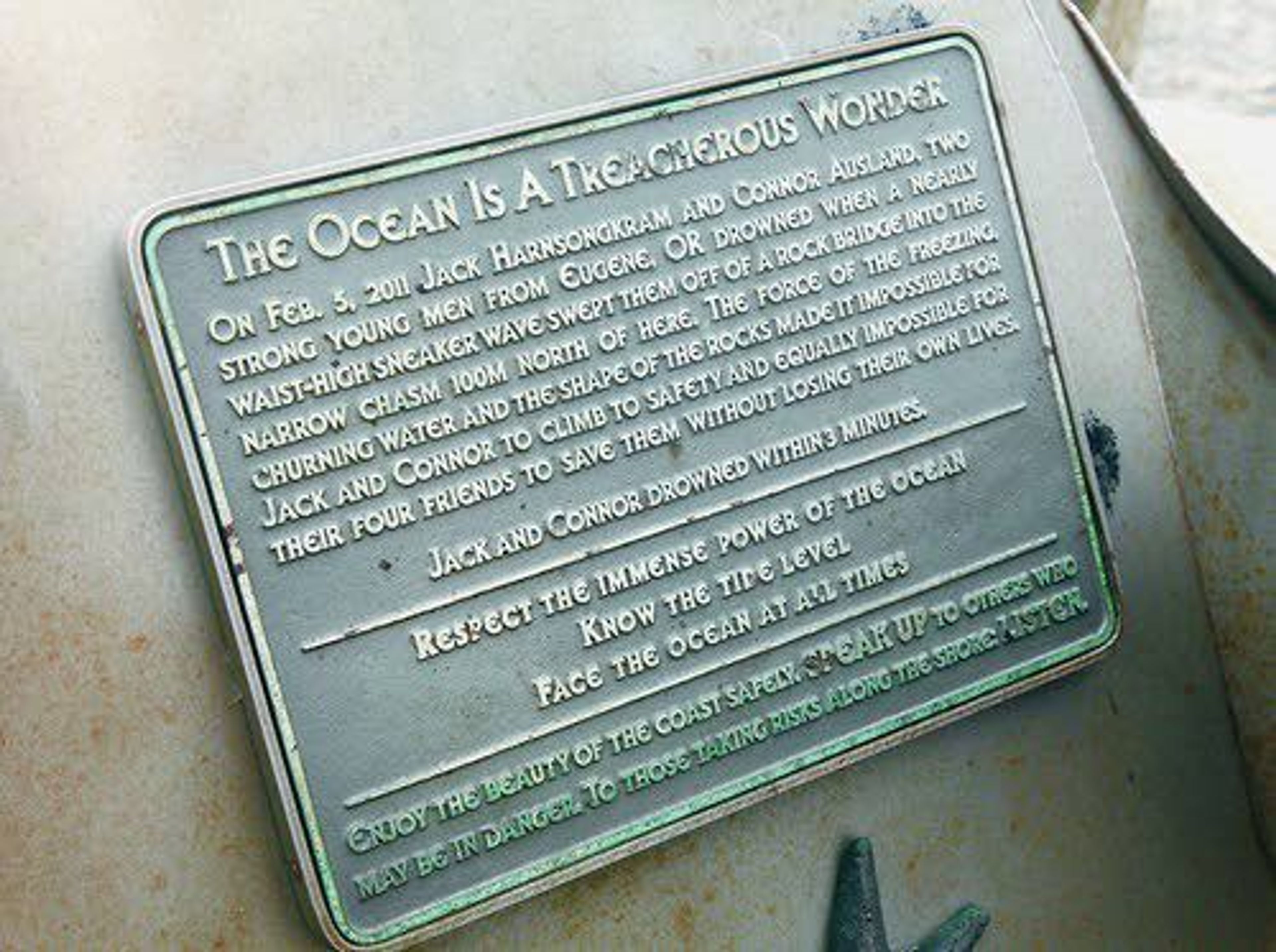 This July photo shows a memorial plaque honoring Connor Ausland and Jack Harnsongkram at Smelt Sands State Recreation Site near Yachats, Ore. The two Oregon teens were swept out to sea by a sneaker wave at the park in 2011.