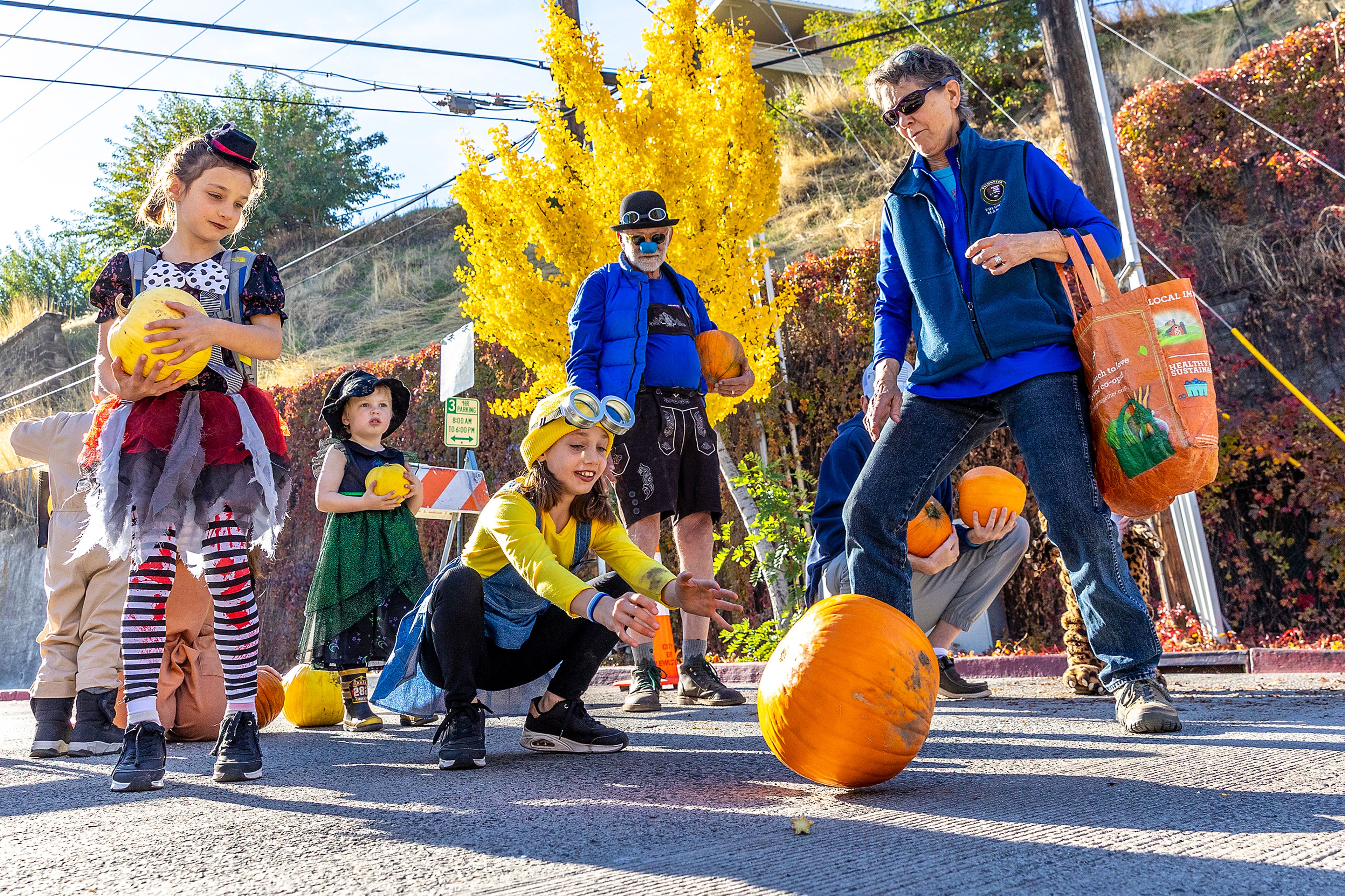 Melody Cadez-Schmidt, 10, rolls a pumpkin down the hill at the Great Pumpkin Roll Saturday at Pumpkin Palooza in downtown Lewiston.,