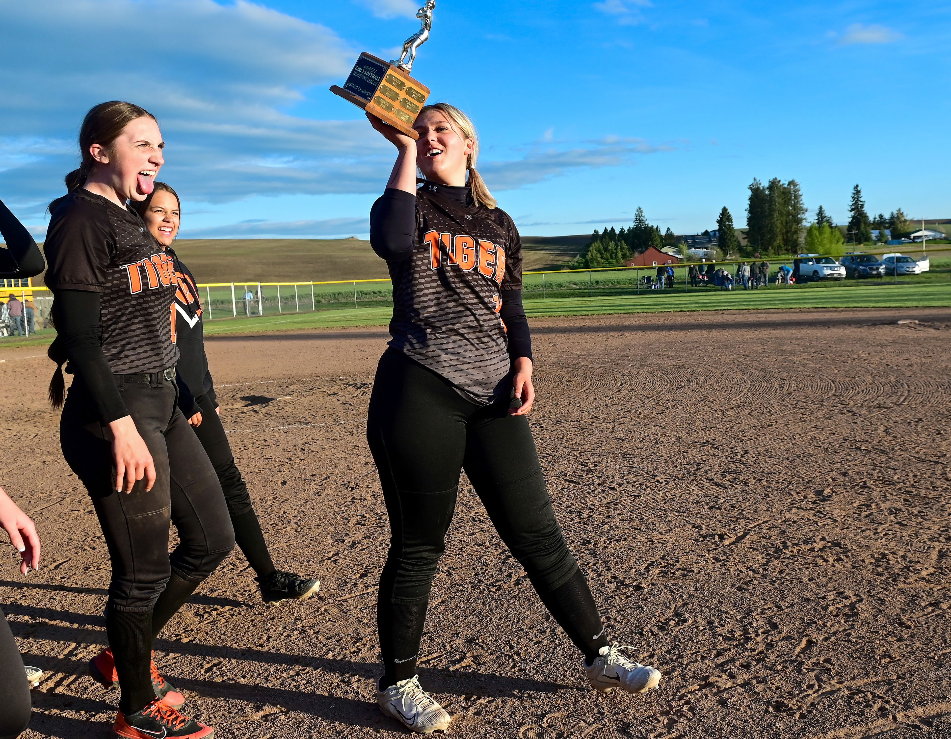 Kendrick’s Taylor Boyer raises the championship trophy as the team celebrates its win against Genesee after an Idaho 2A district tournament championship game Wednesday in Genesee.