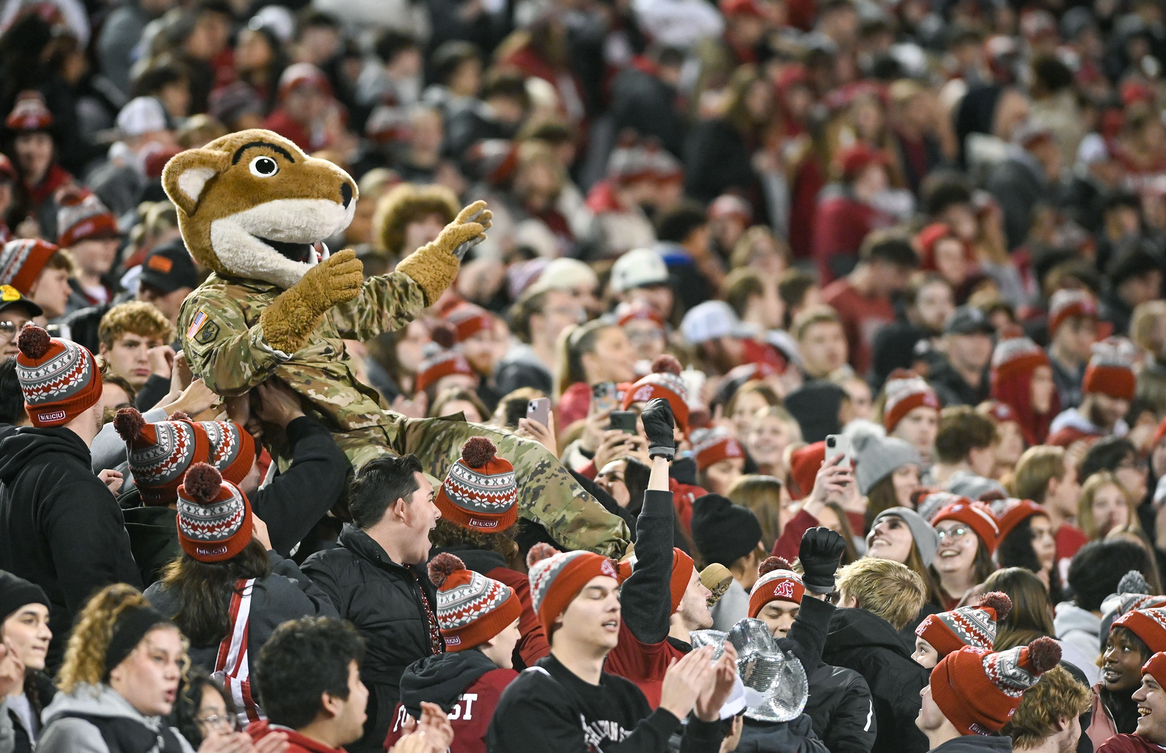 Washington State mascot Butch T. Cougar crowd surfs the student section after a Cougar touchdown Saturday at Gesa Field in Pullman.