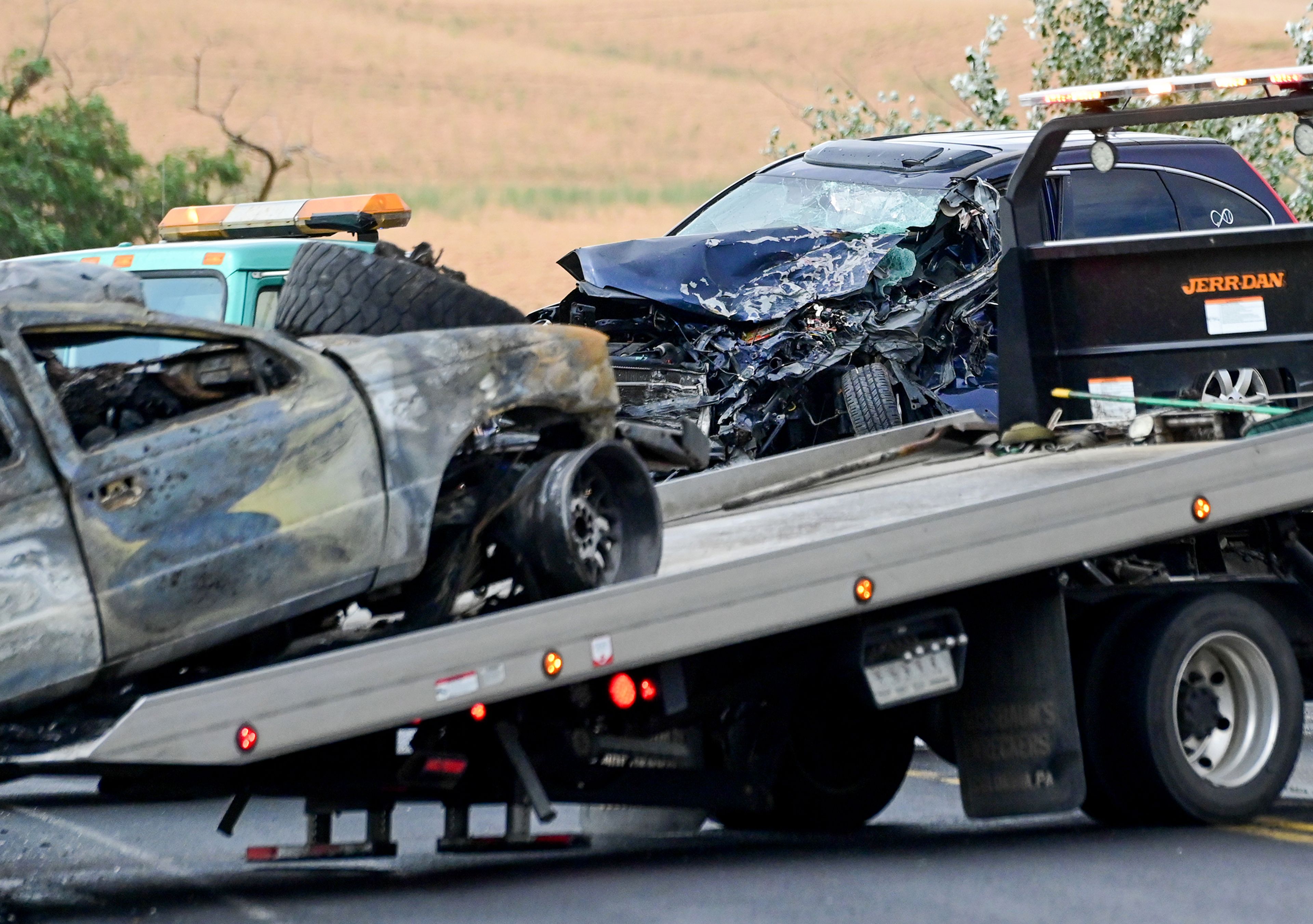 Two cars involved in a car crash along U.S. Highway 95 south of Moscow on Monday are loaded on to tow trucks near milepost 342.