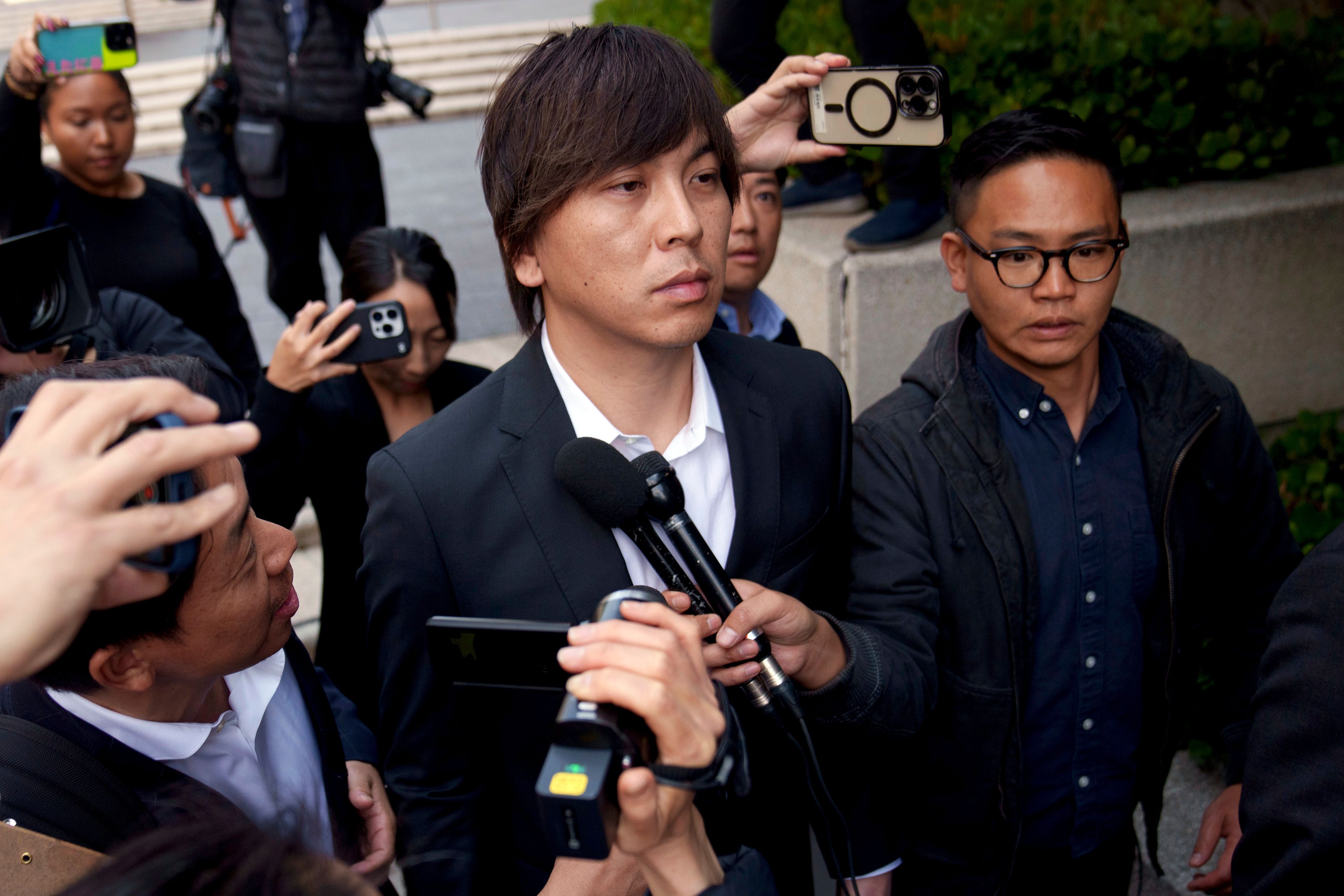 FILE - Ippei Mizuhara, center, the former longtime interpreter for the Los Angeles Dodgers baseball star Shohei Ohtani, leaves federal court following his arraignment, Tuesday, May 14, 2024, in Los Angeles. Mizuhara is scheduled to plead guilty Tuesday, June 4, 2024, to bank and tax fraud in a sports betting case where he is expected to admit to stealing nearly $17 million from the Japanese baseball player.