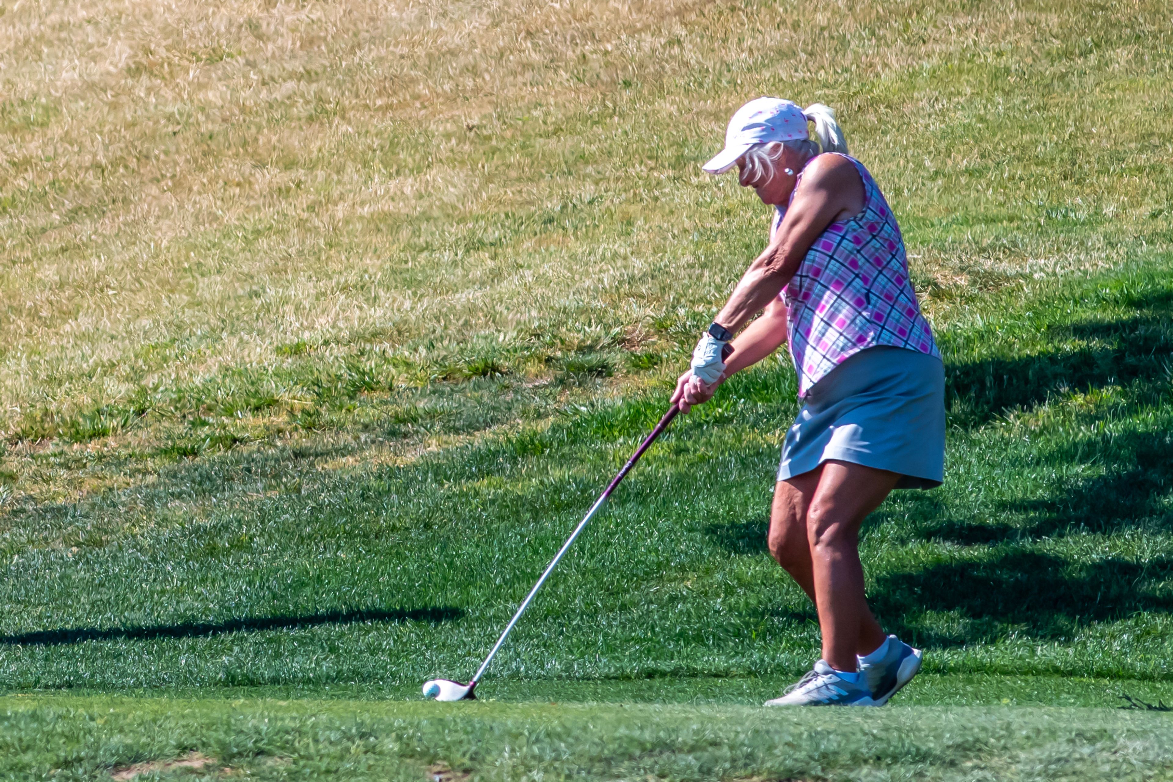 Marcy Spilker, with Lewiston Golf and Country Club, hits her ball during the Tribune Cup golf tournament at Quail Ridge Golf Course on Tuesday in Clarkston.