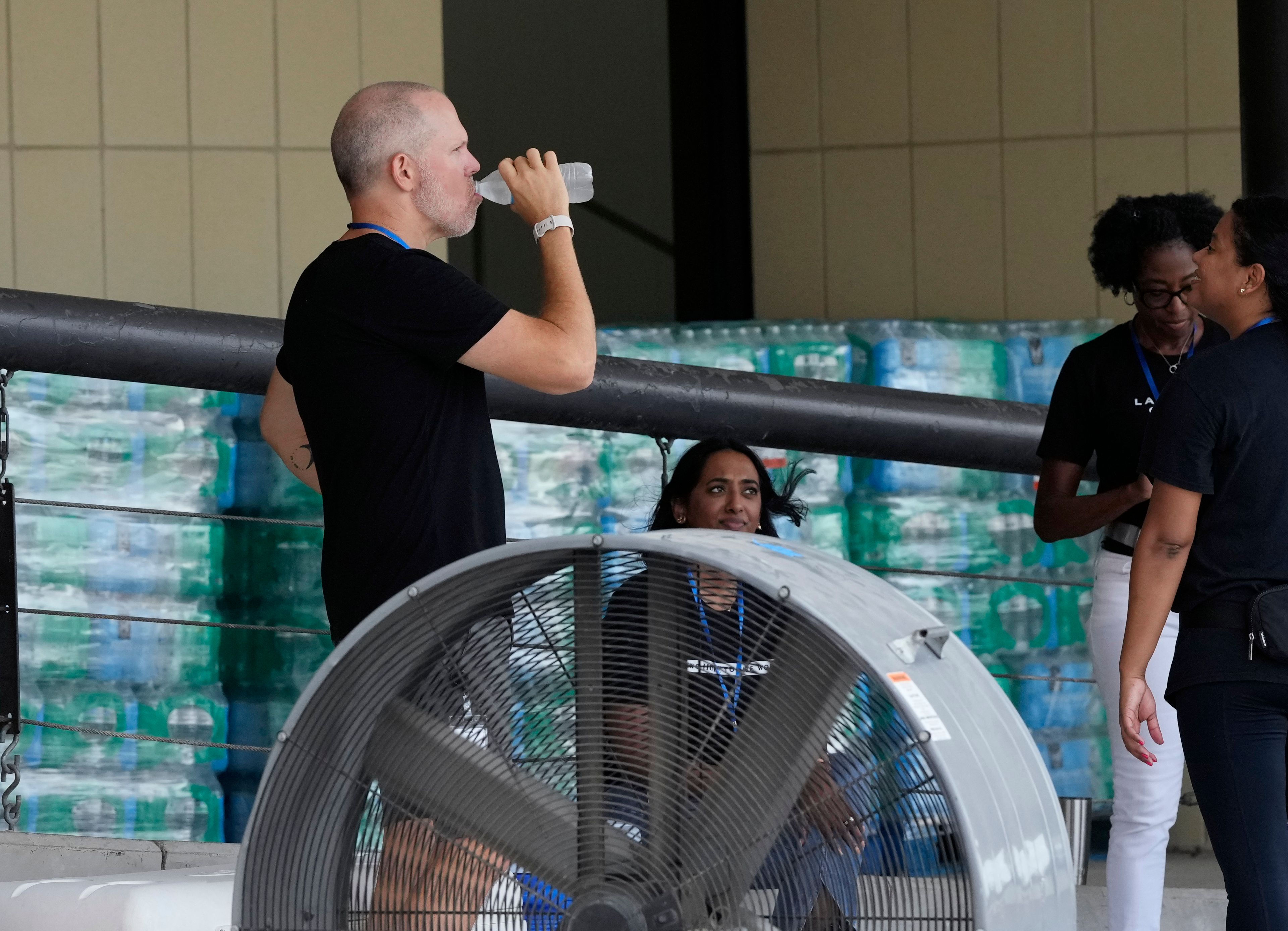 Staff at Lakewood Church operate a cooling station and water distribution line in Houston, Tuesday, July 9, 2024. The effects of Hurricane Beryl left most in the area without power. (AP Photo/Eric Gay)