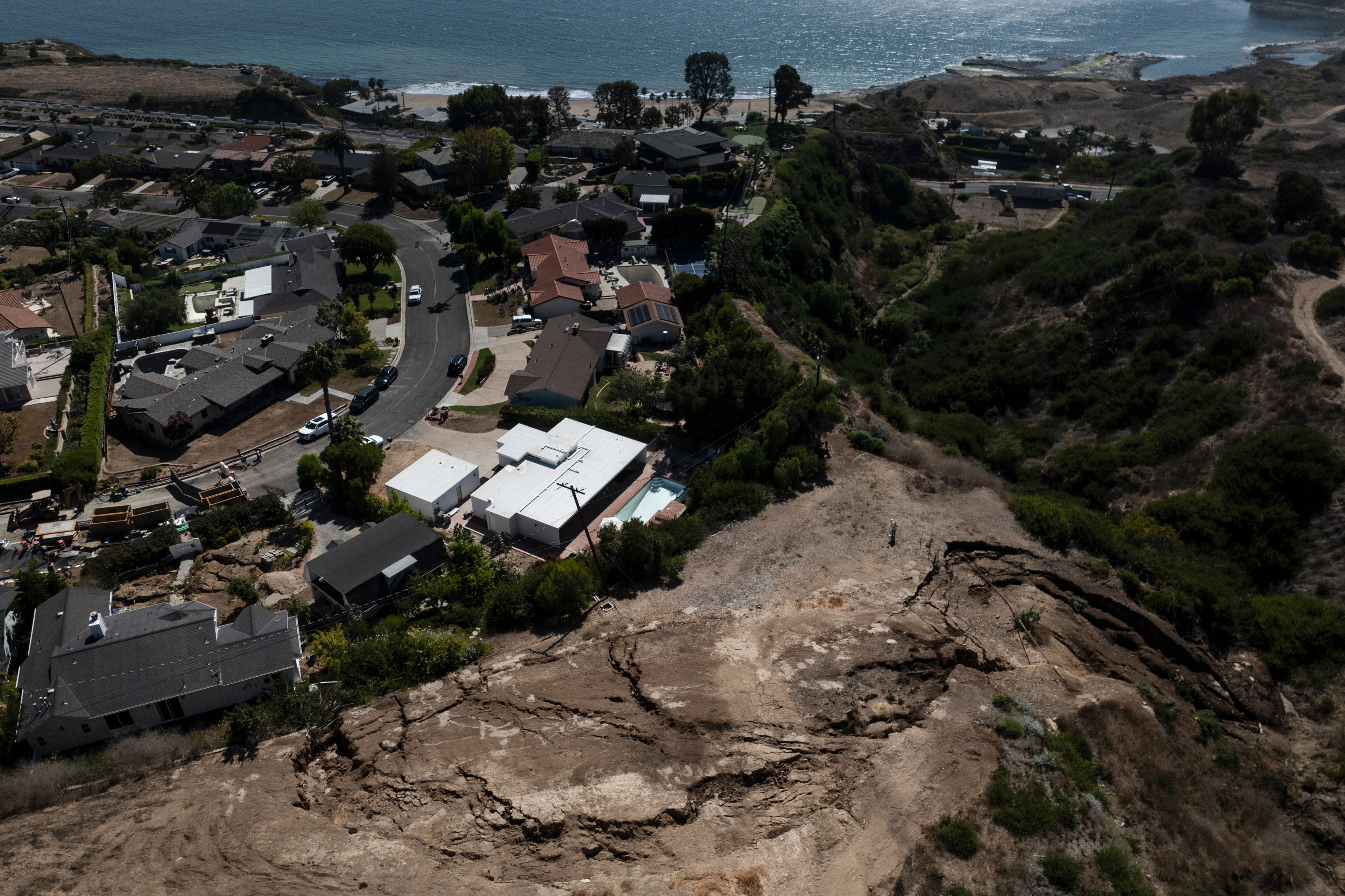 An aerial view shows a neighborhood damaged by ongoing landslides in Rancho Palos Verdes, Calif., Tuesday, Sept. 3, 2024.