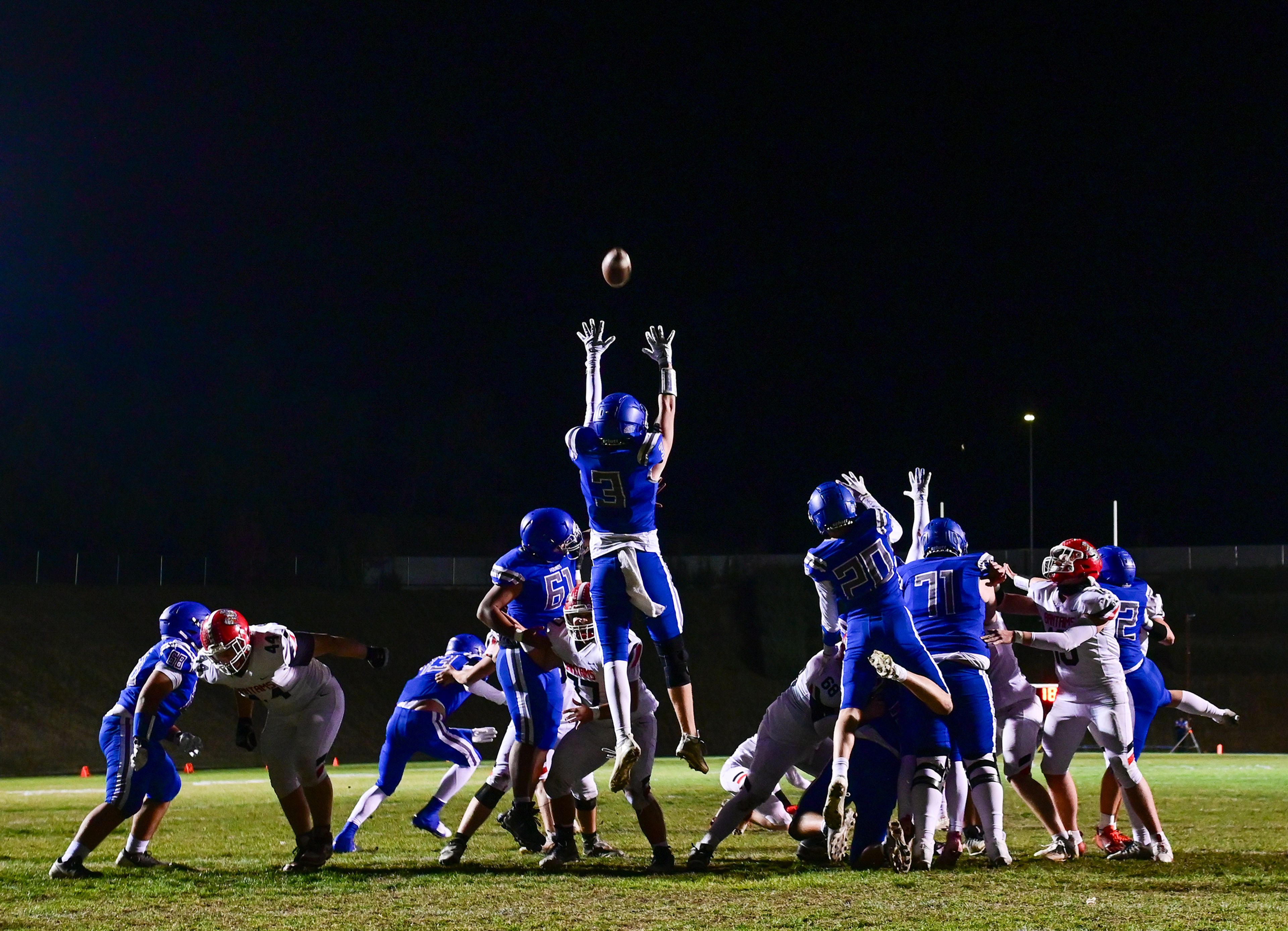 Pullmans Evan Anderson jumps in an attempt to block an extra point from Clarkston Friday in Pullman.,