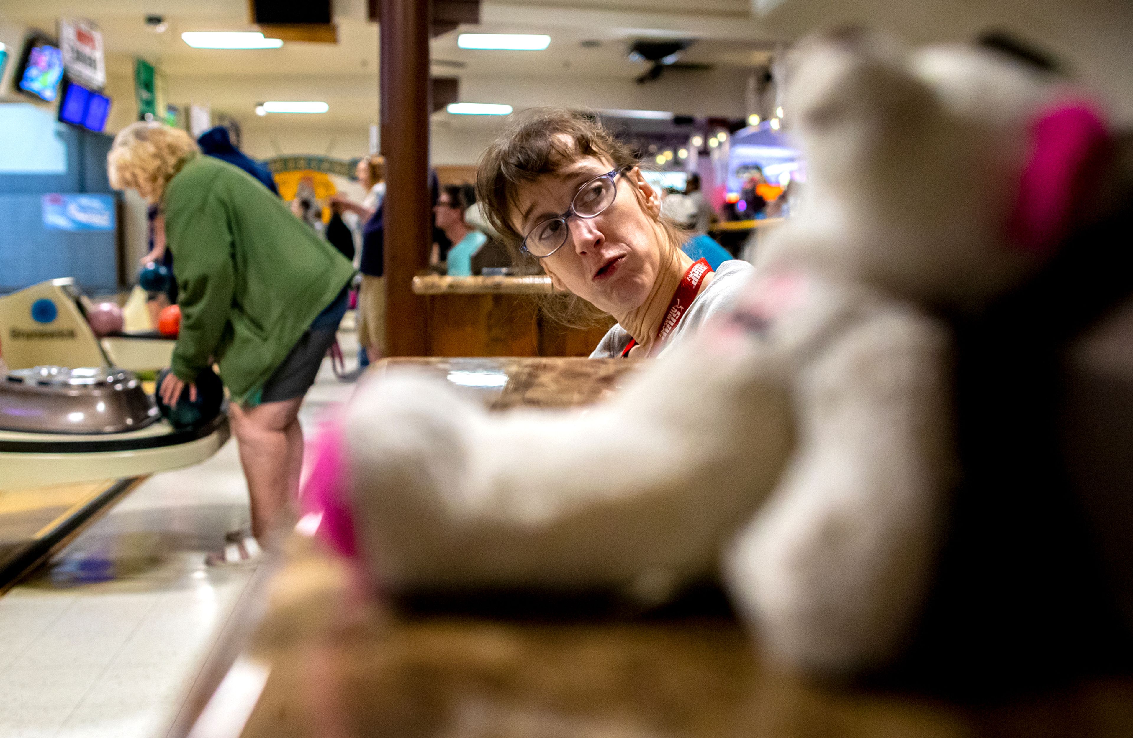 Leah Wells, of the Twin Rivers Special Olympics of Washington, waits for her turn to roll some rocks during a team practice Saturday morning at Lancer Lanes in Clarkston.