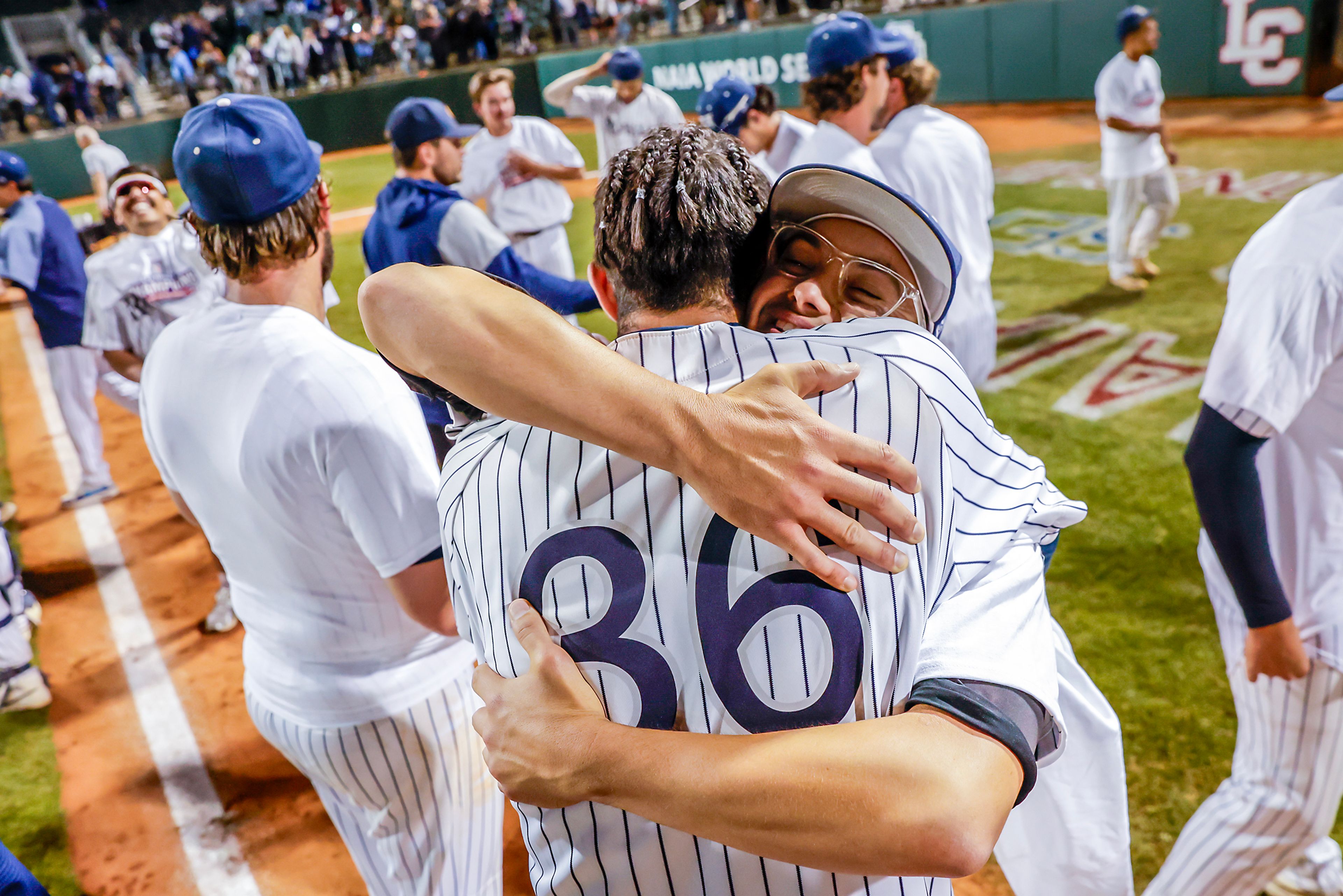 Hope International players celebrate their 13-6 victory over Tennessee Wesleyan in Game 19 of the NAIA World Series at Harris Field Friday in Lewiston.