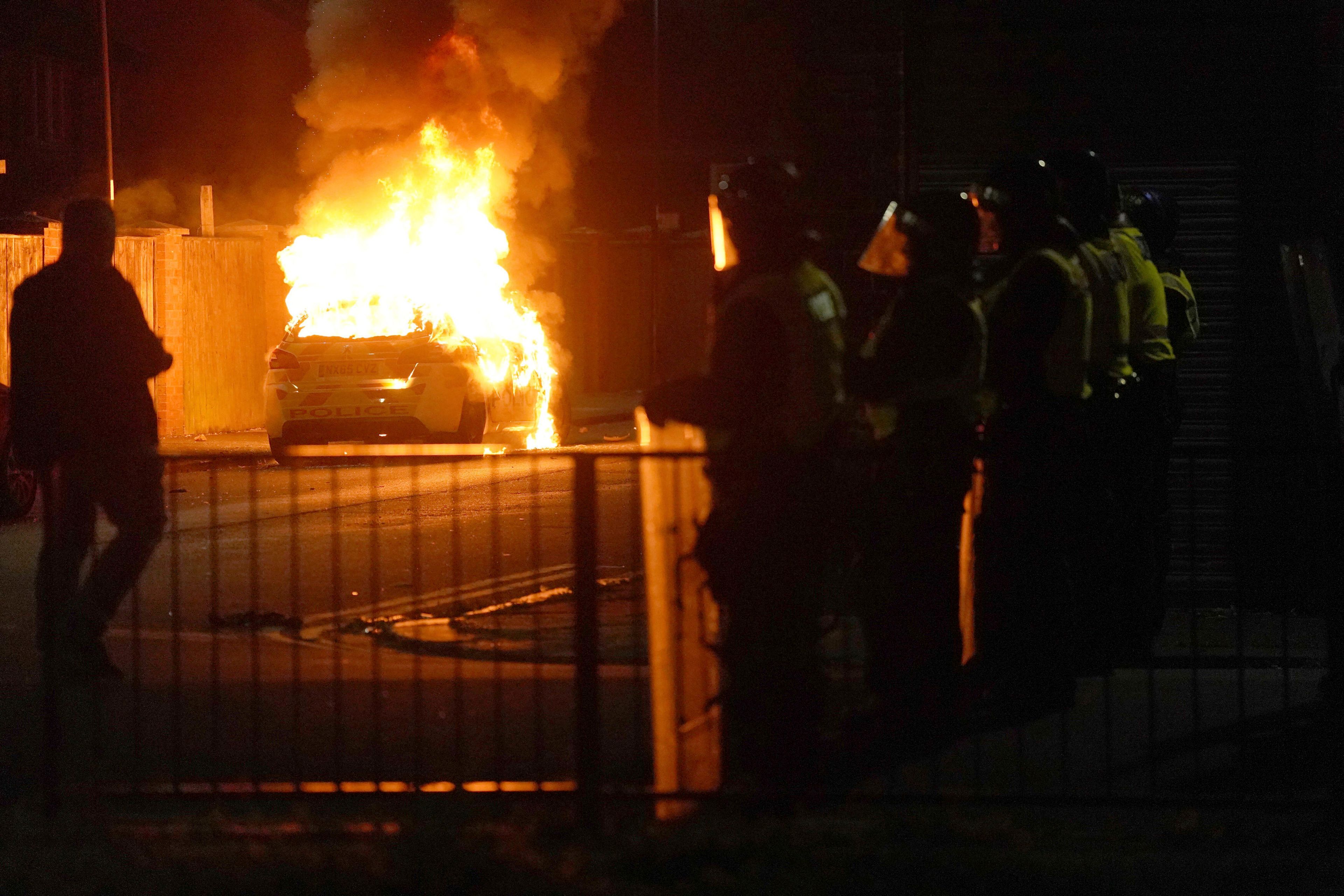 A police car burns as officers are deployed on the streets of Hartlepool, England, following a violent protest in the wake of the killing of three girls who were fatally stabbed in northwest England, Wednesday, July 31, 2024. Far-right groups seek to stir anger over an attack they have sought to link â€” without evidence â€” to immigrants. (Owen Humphreys/PA via AP)