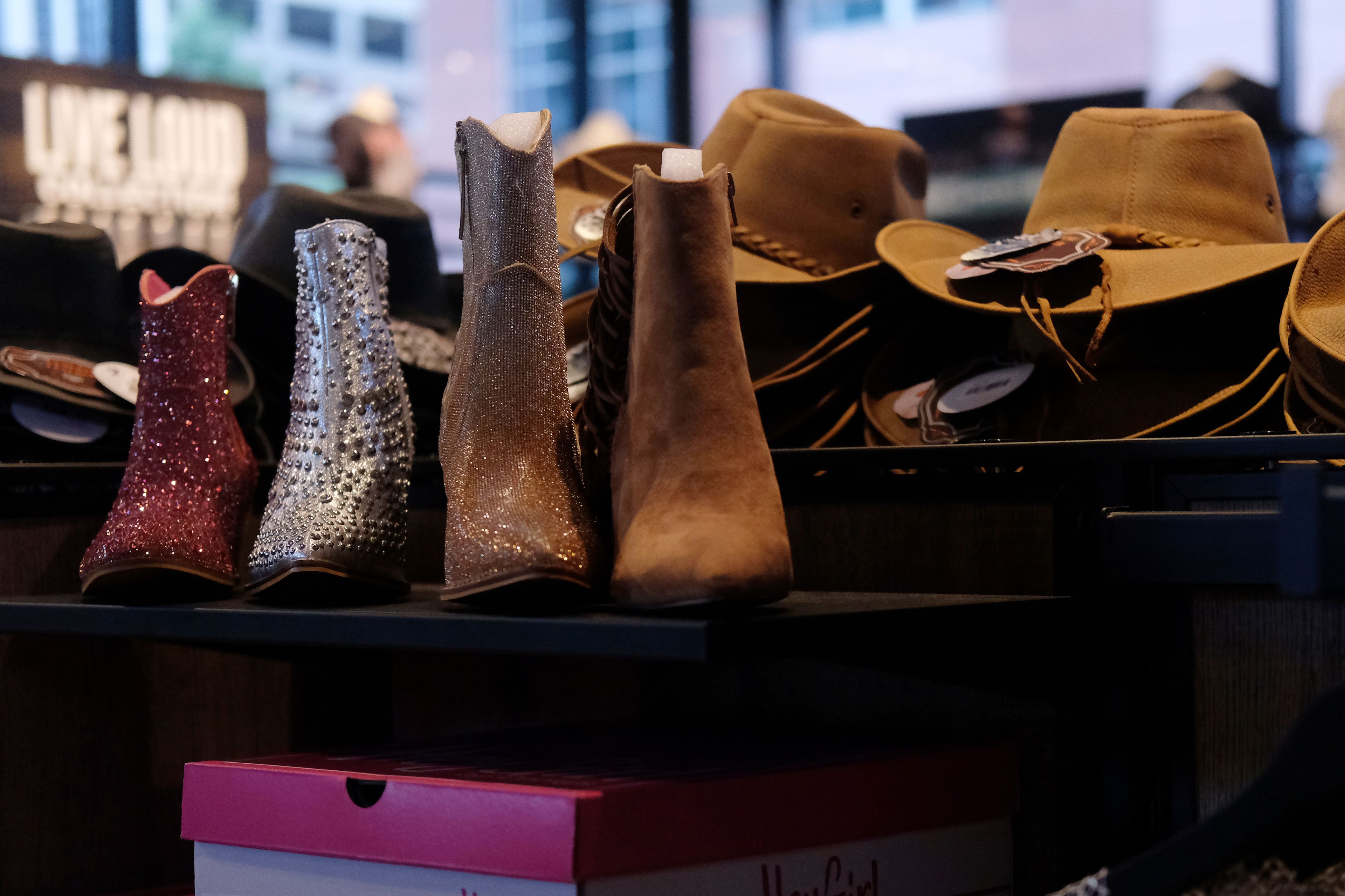 Cowboy hats and boots are displayed at the Ryman Auditorium gift shop in Nashville, Tenn., on July 30, 2024.