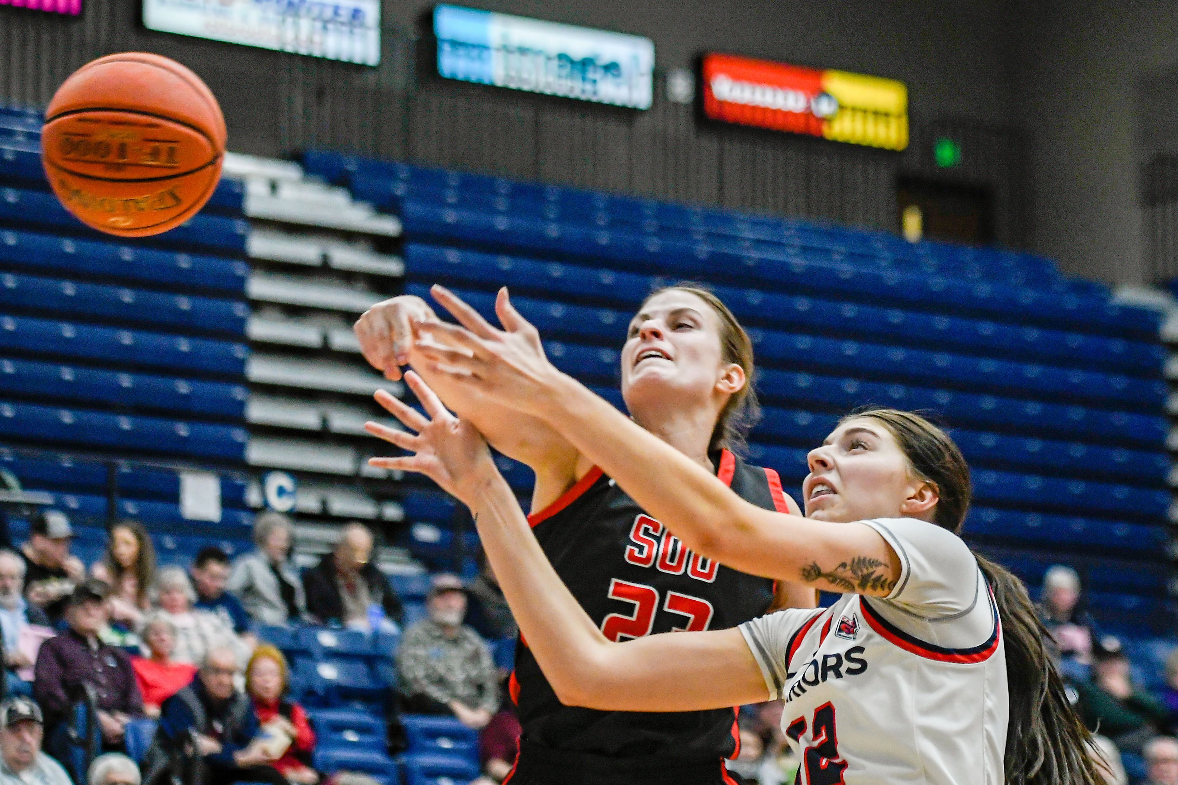 Lewis-Clark State post Sara Muehlhausen, right, has the ball knocked loose by Southern Oregon forward Clara Robbins during Saturday's Cascade Conference game at the P1FCU Activity Center.