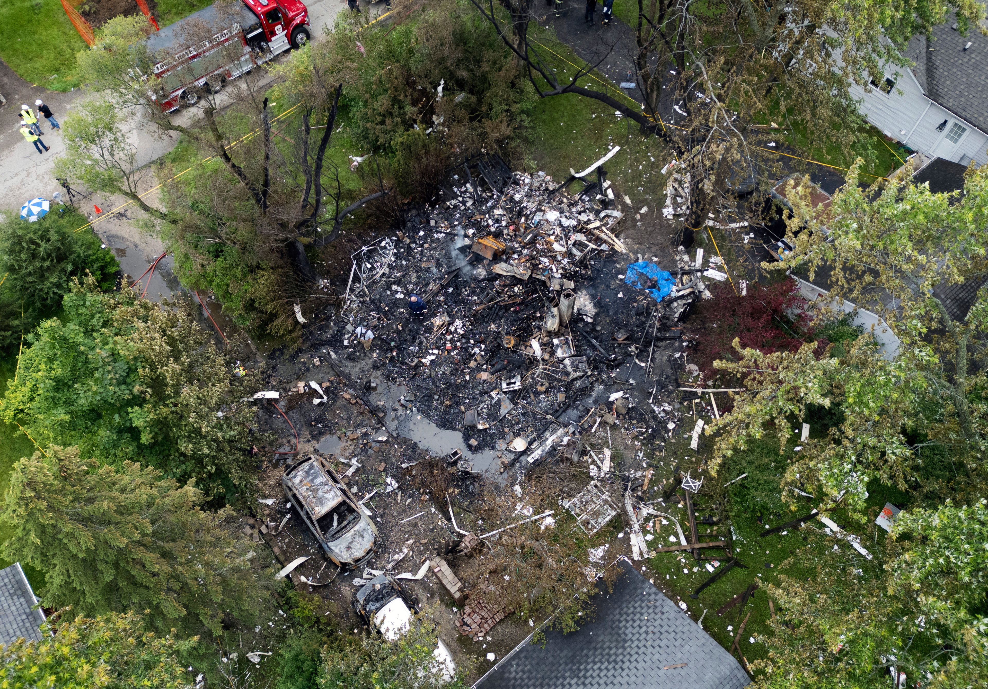 FILE - Investigators and firefighters remain on the scene after an explosion destroyed a home in unincorporated Lake Zurich, Ill., Wednesday, June 5, 2024. The Lake County Coroner’s Office identified the man found in the house explosion as Timothy Toczylowski Friday, Jan 7. He was a resident of the home, authorities said.