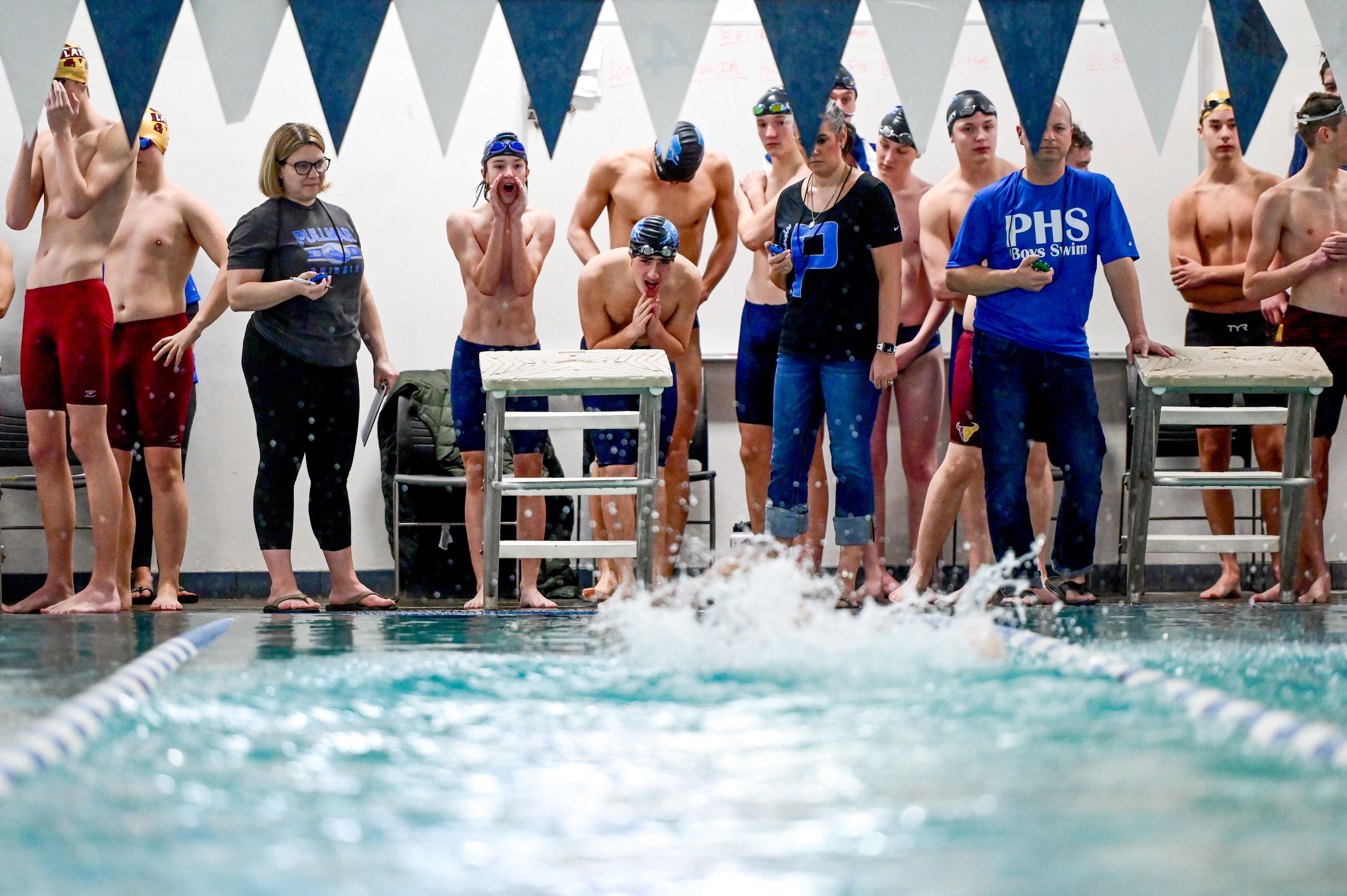 Pullman teammates cheer for junior Jake McCoy during the final leg of a 200-yard freestyle relay at a meet with Moses Lake Jan. 22 in Pullman.