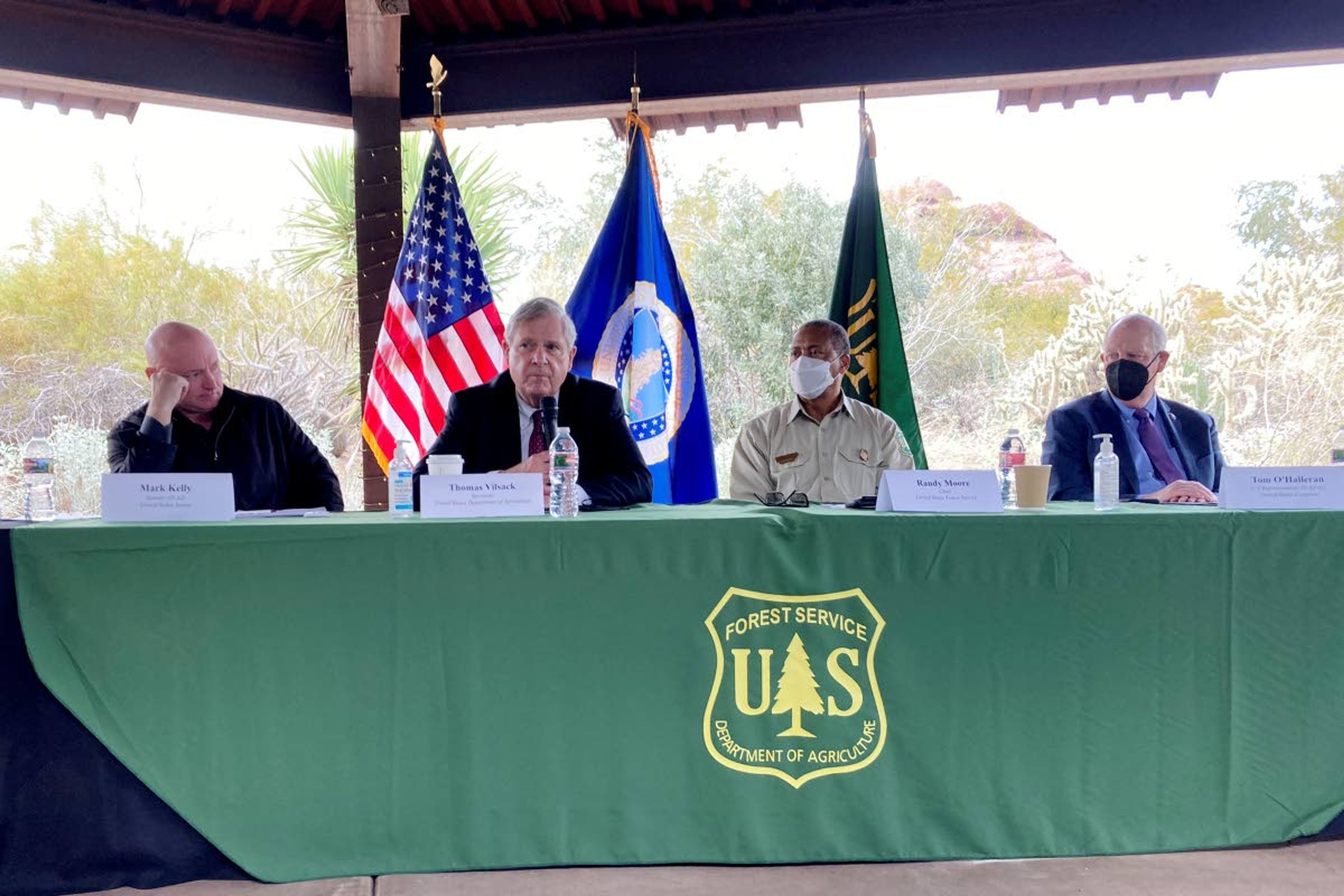 U.S. Sen. Mark Kelly, D-Ariz., left, Agriculture Secretary Tom Vilsack, Forest Service Chief Randy Moore and U.S. Rep. Tom O'Halleran, D-Ariz., discuss forest fires at the Desert Botanical Garden in Phoenix on Tuesday, Jan. 18, 2022. The Biden administration plans to significantly expand efforts to stave off catastrophic wildfires that have torched areas of the U.S. West. (AP Photo/Jonathan J. Cooper)