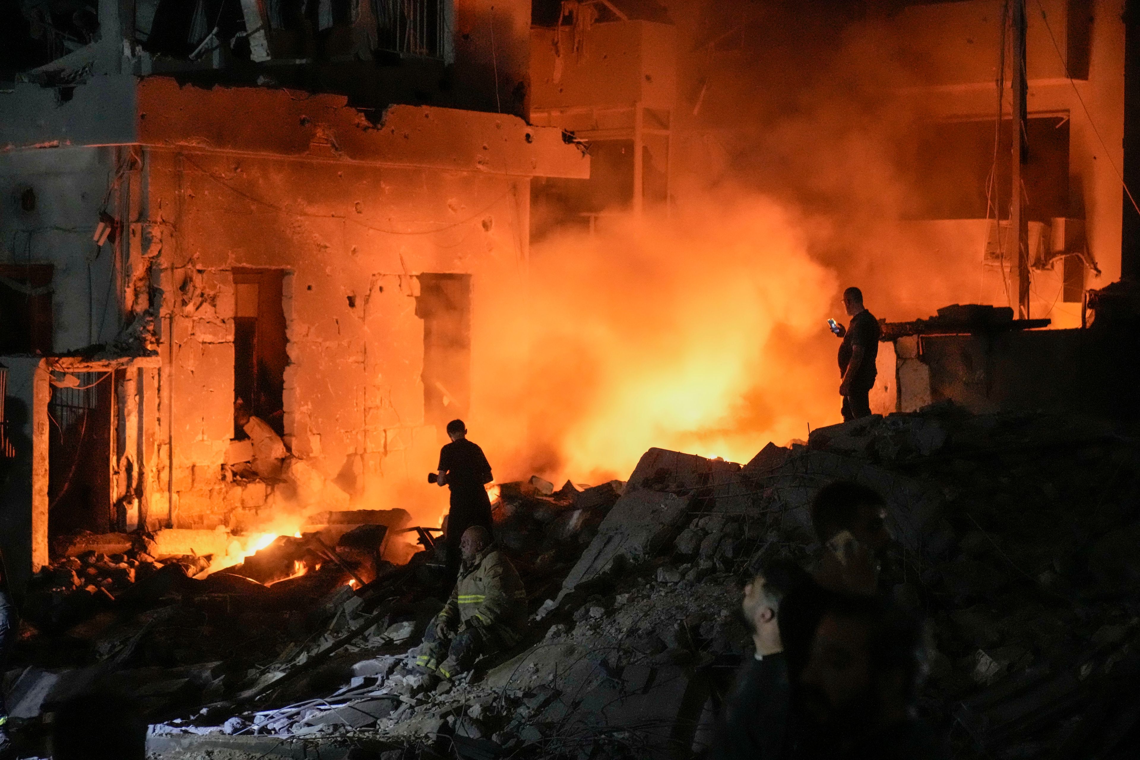 Flames and smoke rise at the scene of destroyed buildings hit by an Israeli airstrike in central Beirut, Lebanon, Thursday, Oct. 10, 2024. (AP Photo/Bilal Hussein)