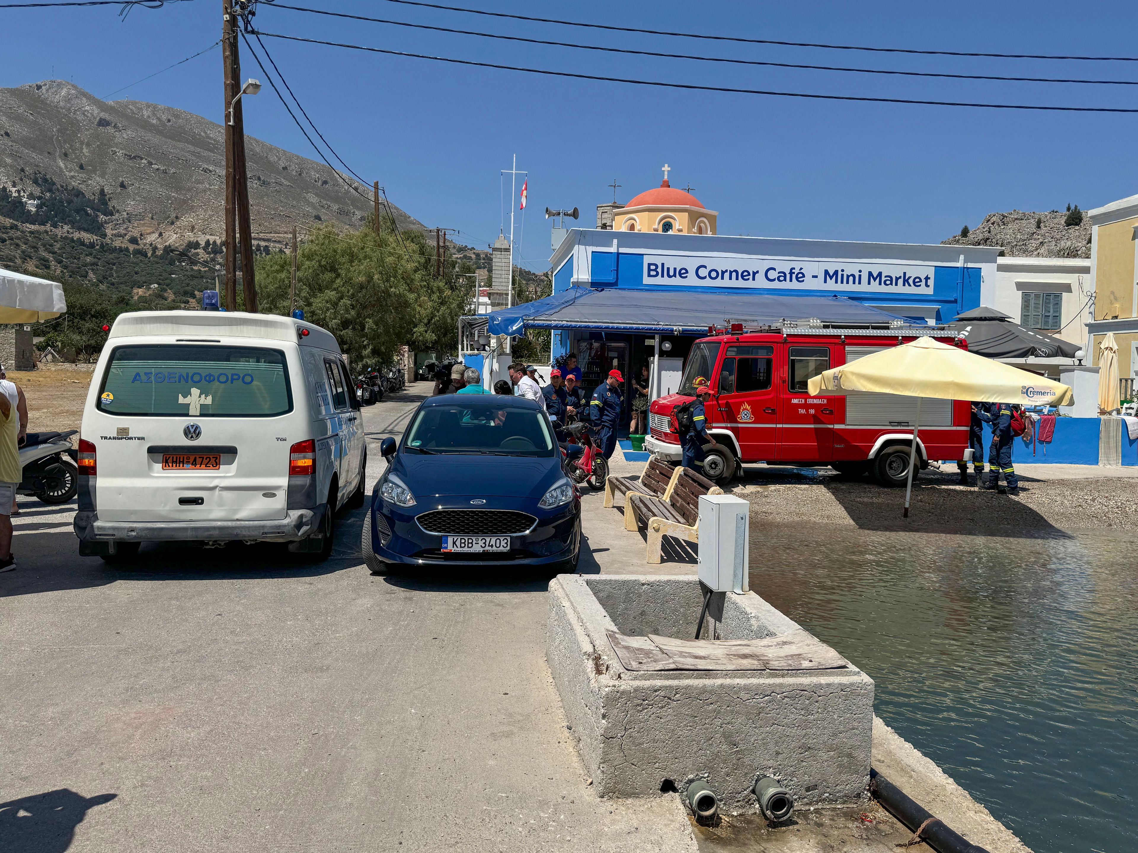 A view of an ambulance and a fire brigade van are on a beachfront of Symi island, Greece, Sunday, June 9, 2024. Police said that a body believed to be that of missing British TV presenter Michael Mosley was found on a Greek island Sunday morning.