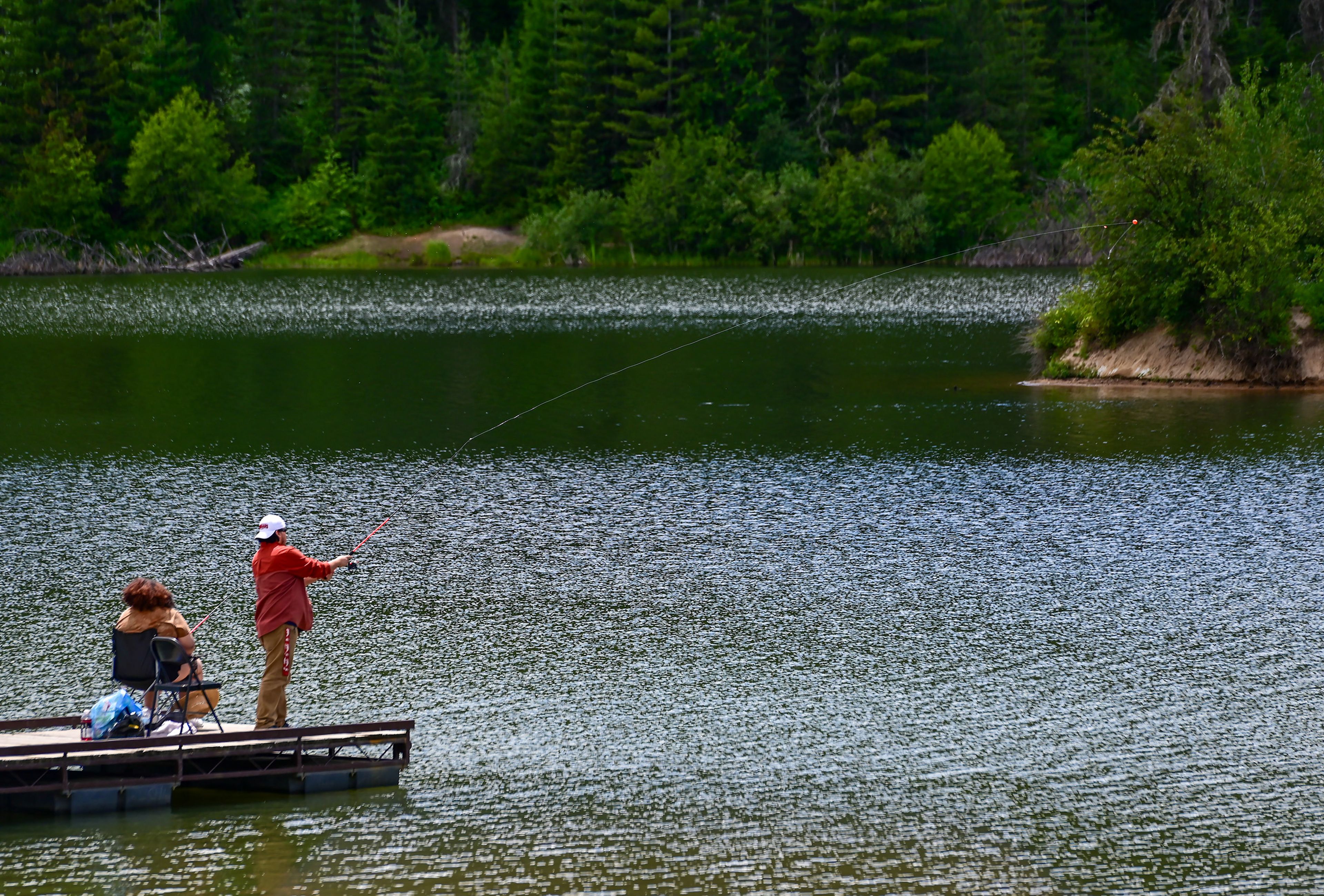 Deanna Whitley, left, a recent Washington State University alum, and Carlos Romero, a 4th year student at WSU, fish off the edge of a pier at the Spring Valley Reservoir outside of Troy on Friday.