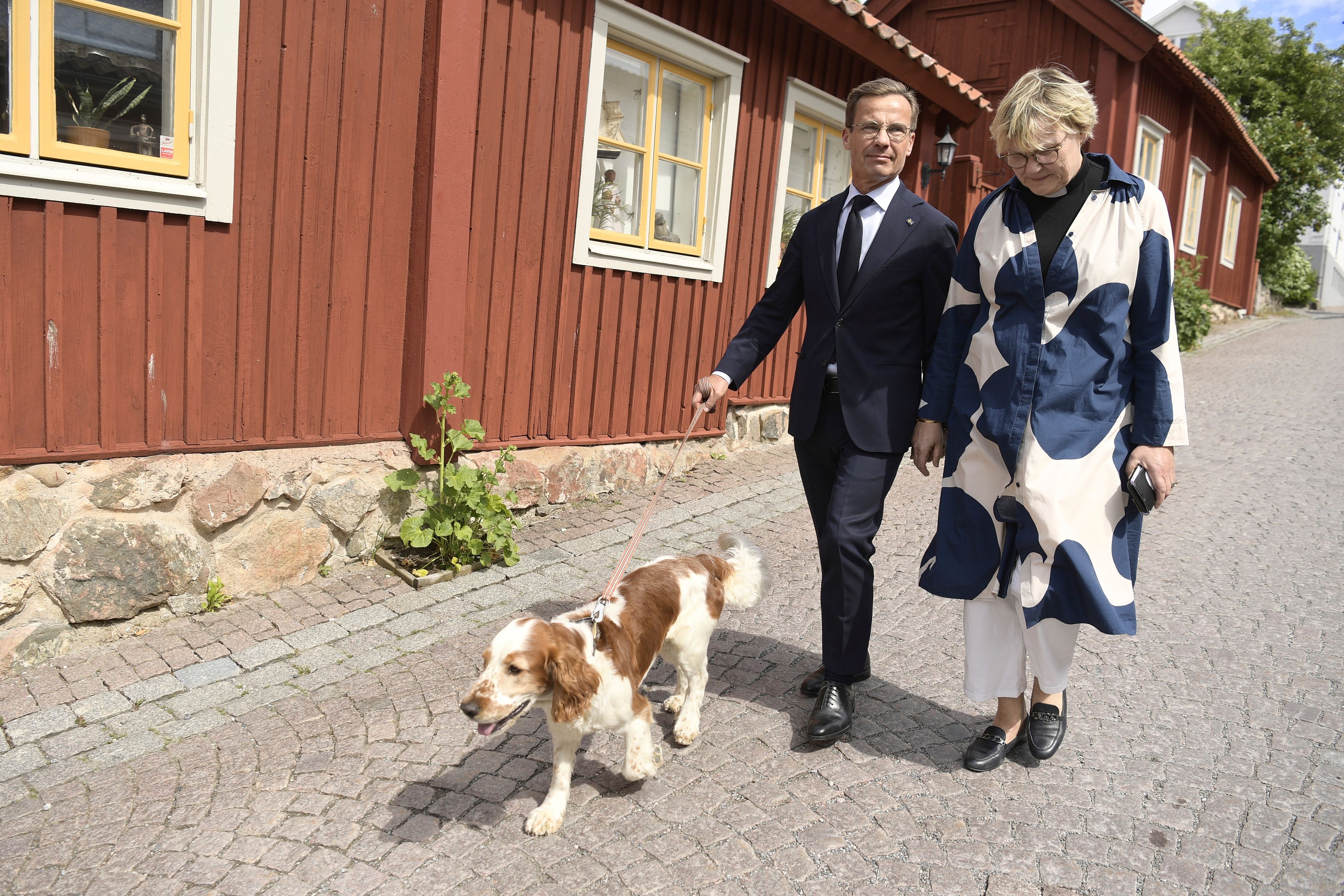 Sweden's Prime Minister Ulf Kristersson, and his wife Birgitta Ed, right, walk with their dog Winston to the polling station to vote in the European Parliament election, in his hometown Strangnas, in Sweden, on Sunday June 9, 2024.