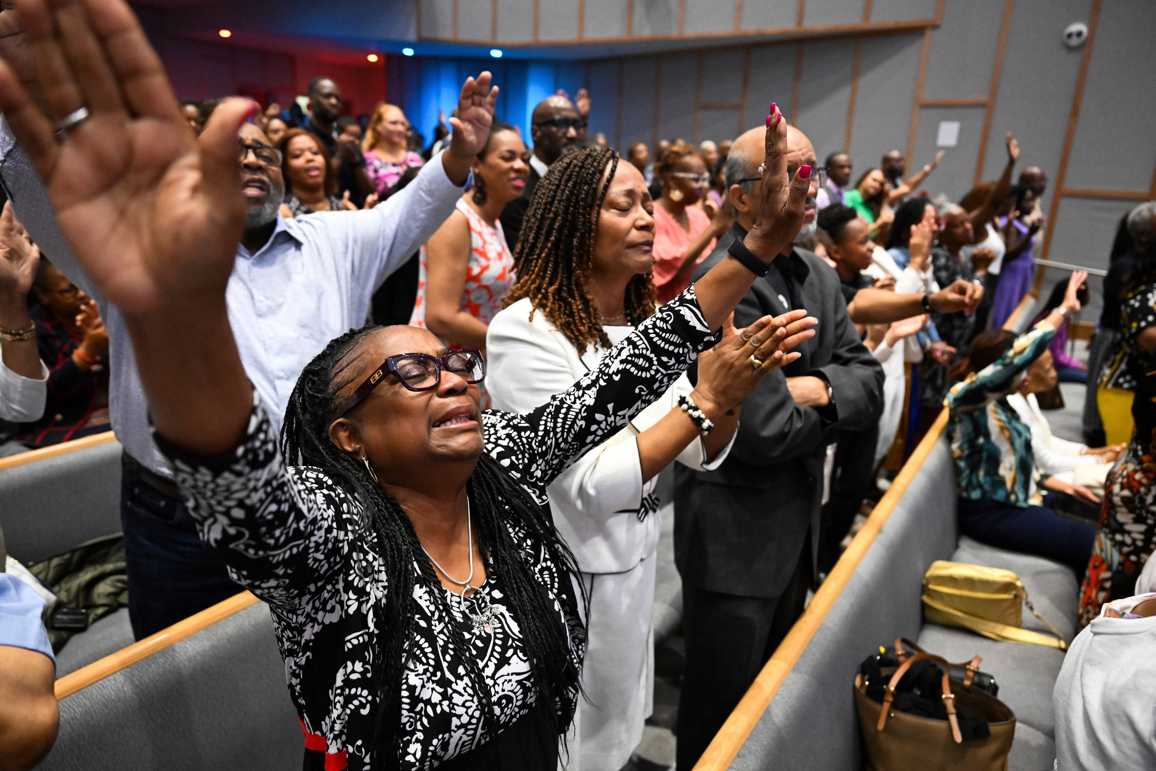 Members of the congregation at Kingdom Fellowship AME Church raise their hands in praise during church service, Sunday, June 2, 2024, in Calverton, Md. The suburban Maryland congregation, led by the Rev. Matthew L. Watley, has landed at the top of a list of the fastest-growing churches in America.