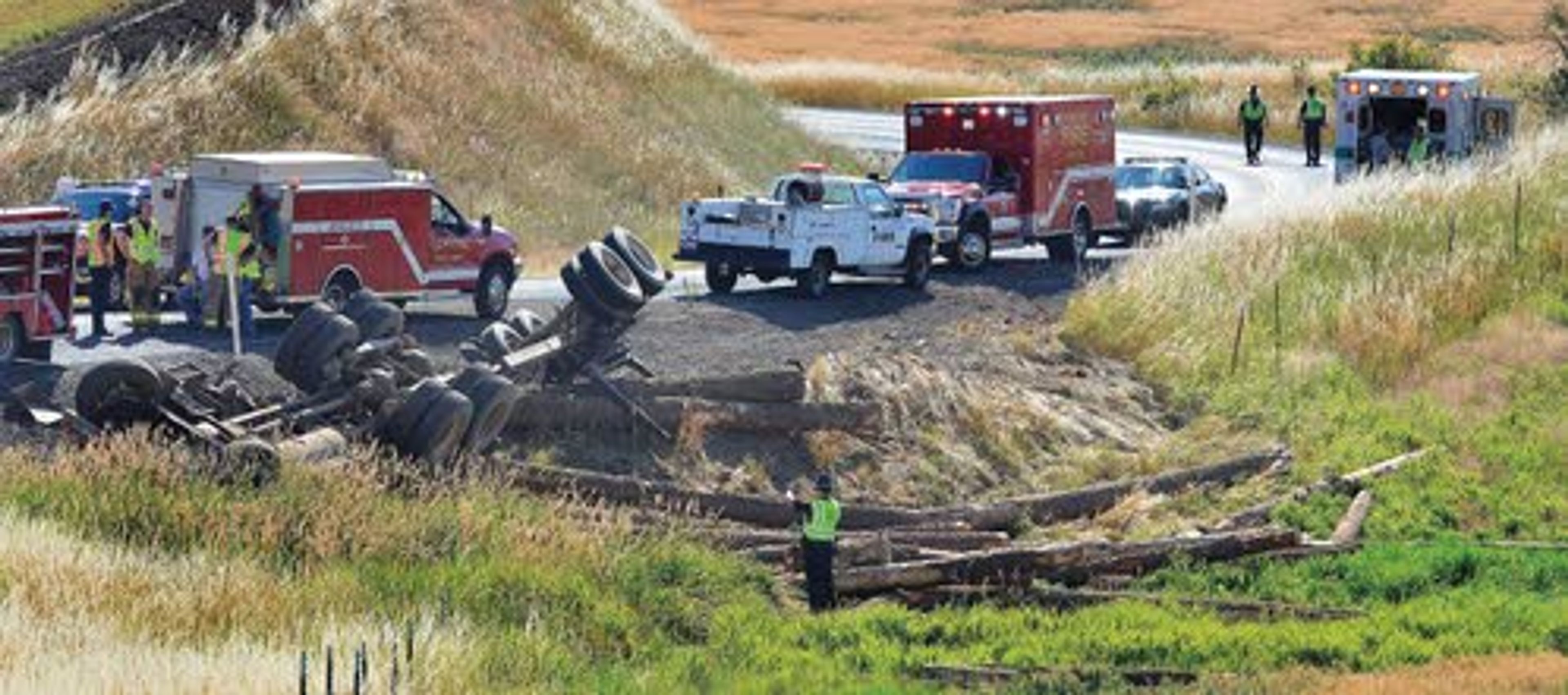 Idaho State Police troopers work to investigate the cause of a fatal logging truck accident Thursday morning on Southwick Road just outside of Southwick in Nez Perce County.