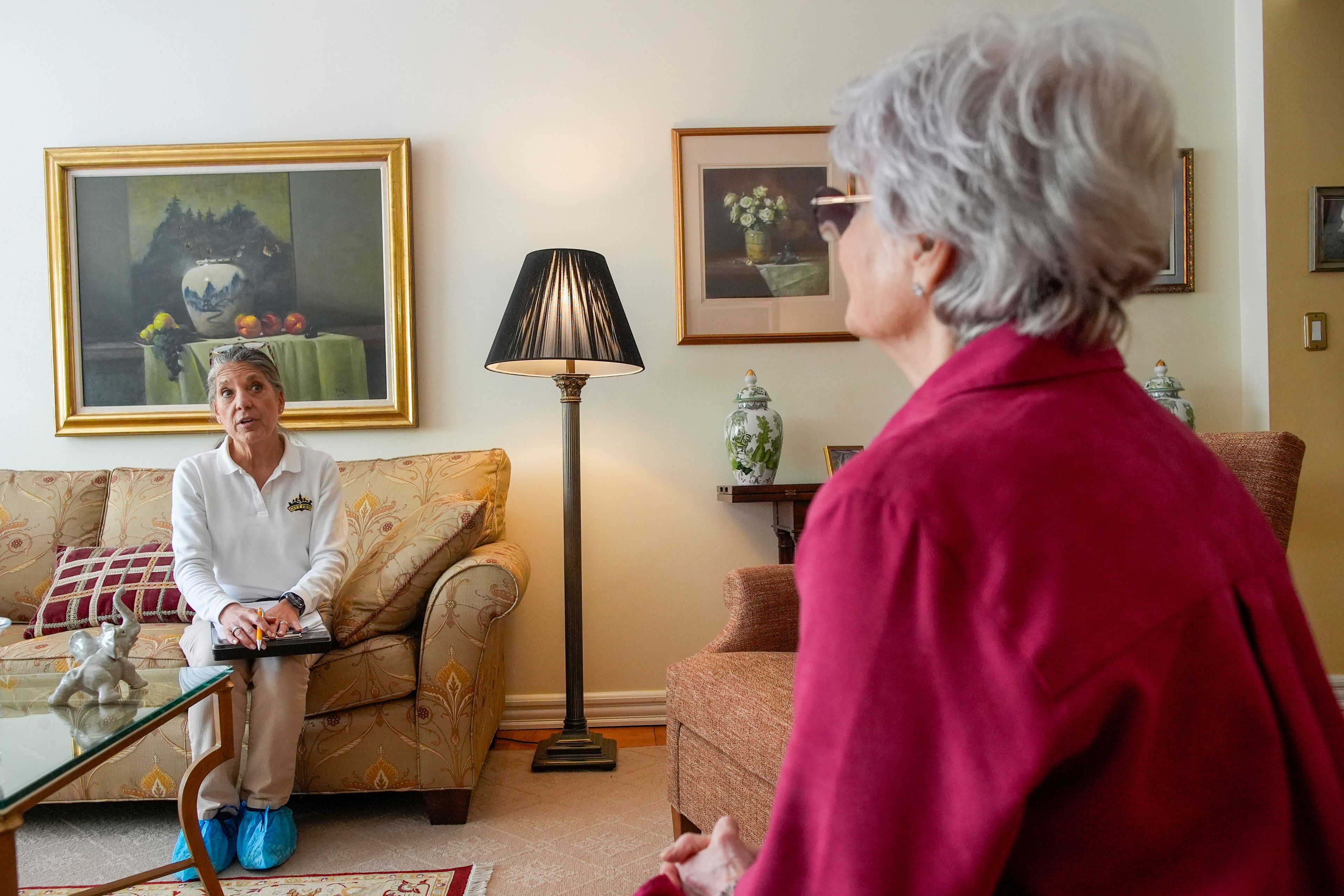 Dr. Amy Attas, left, talks with Lisa Healey about Cody Healey, an 8 year old male Maltese's, symptoms during a house call, Tuesday, April 23, 2024, in New York.