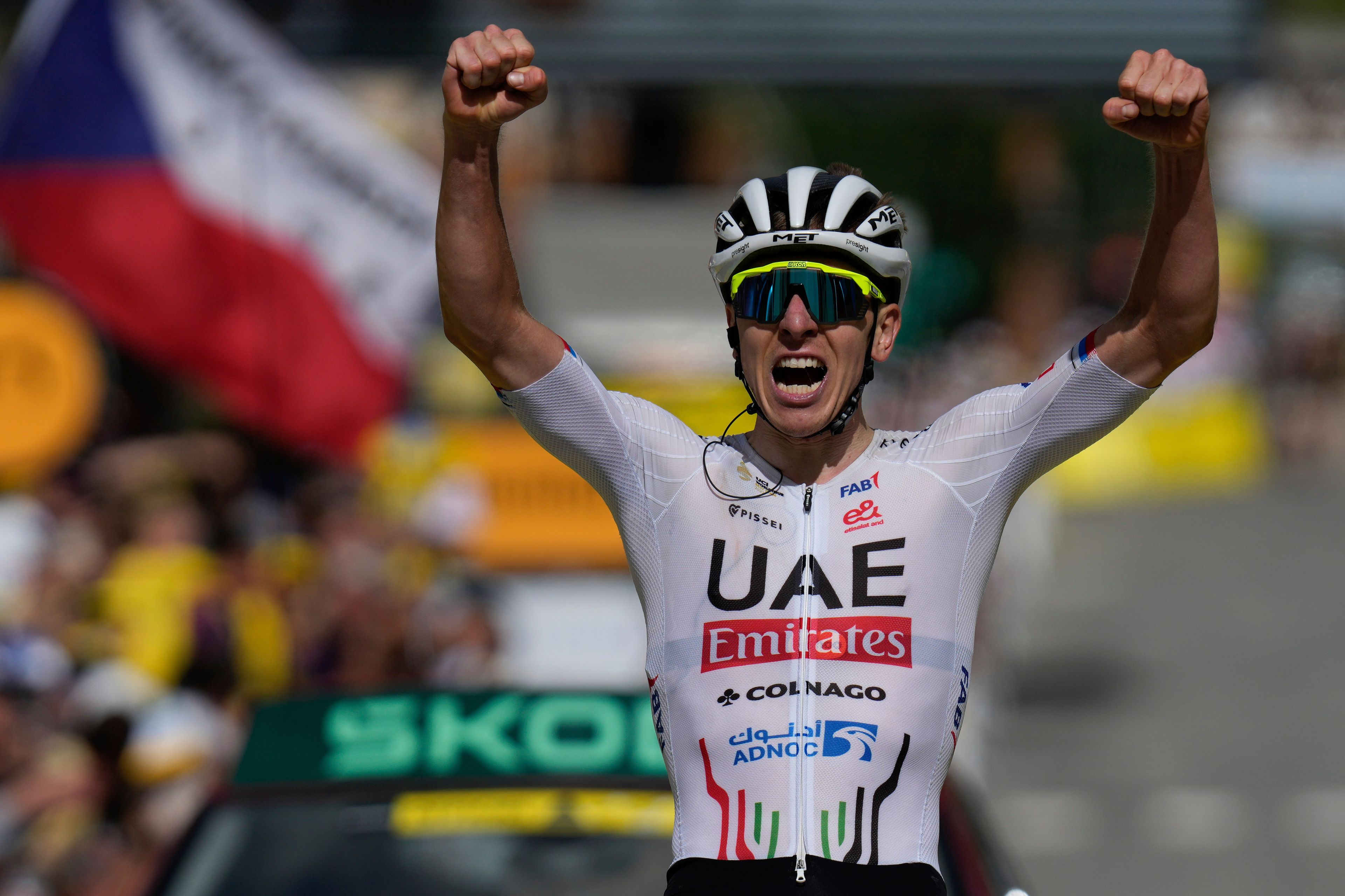 Slovenia's Tadej Pogacar celebrates as he crosses the finish line to win the fourth stage of the Tour de France cycling race over 139.6 kilometers (86.7 miles) with start in Pinerolo, Italy and finish in Valloire, France, Tuesday, July 2, 2024. (AP Photo/Jerome Delay)