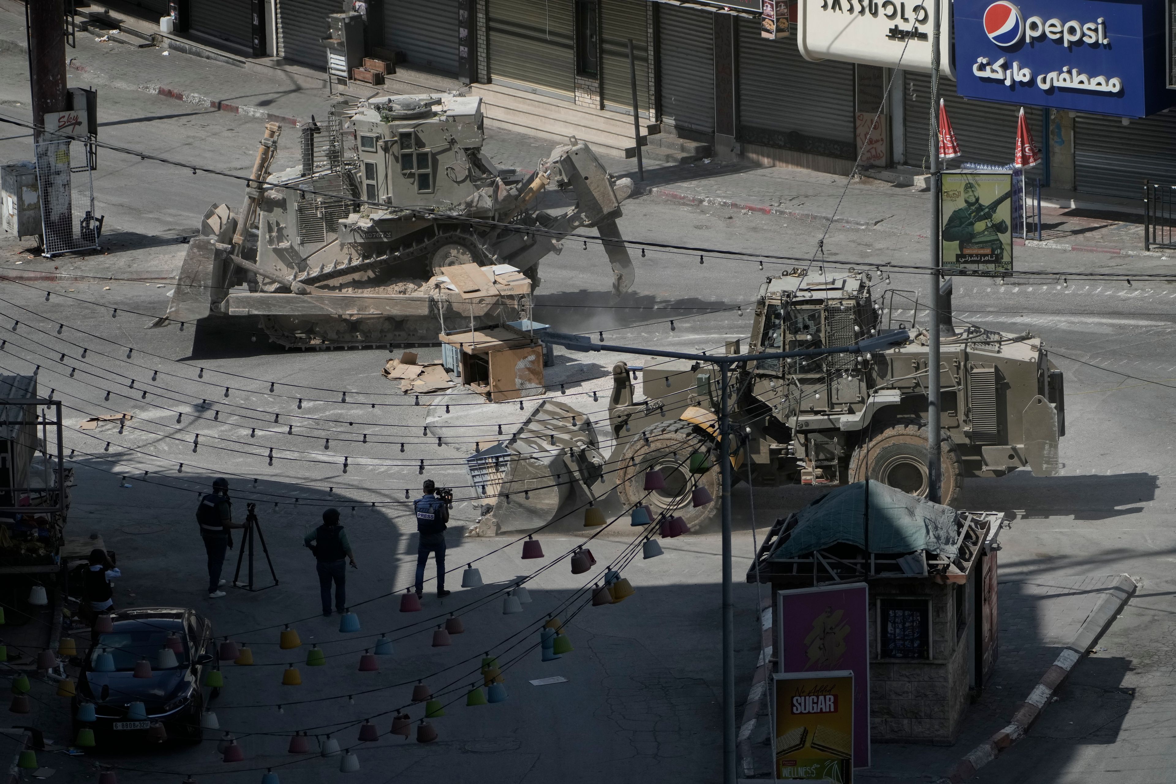 Israeli bulldozers move on a street during a military operation in the West Bank city of Jenin, Saturday, Aug. 31, 2024. (AP Photo/Majdi Mohammed)